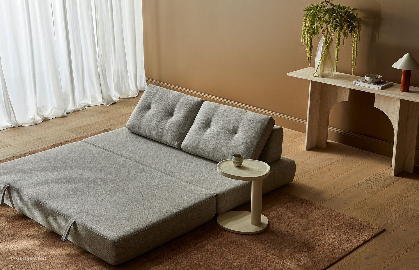 Pictured here: Hugo Gwen Sofa Bed, Archer Console Table, Tolv Islet Side Table, Easton Pinnacle Table Lamp, Boden Ridge Vase, Hanson Eden Set of 3 Bowls, Tepih Neptune Rug (Ginger)