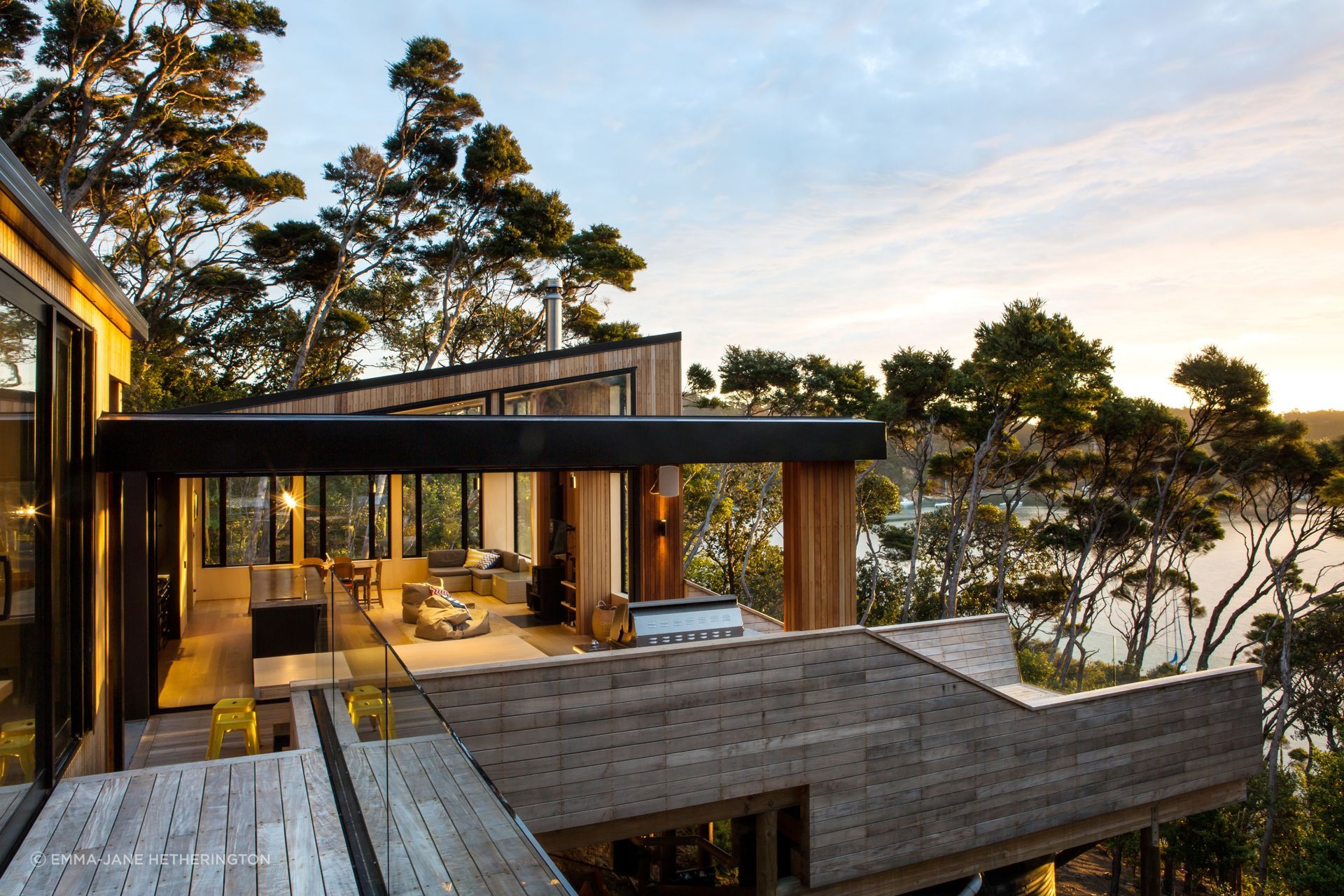 A thoughtfully designed holiday home on Kawau Island, featuring stunning views, a warm timber interior, and a unique layout.