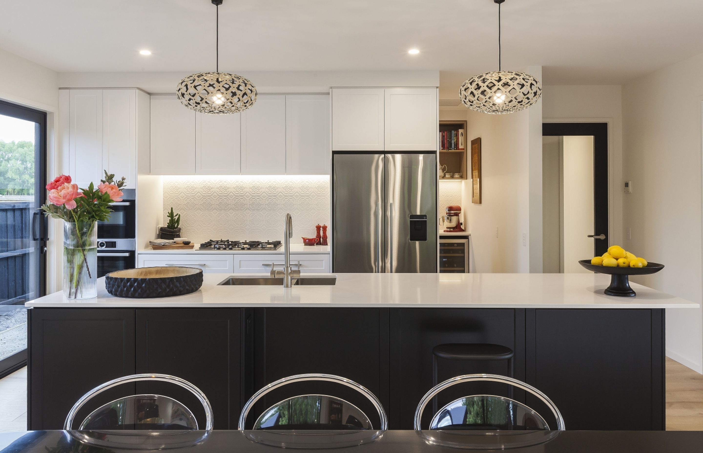 The kitchen in this Tai Tapu home is a chic blend of town and country aesthetics.