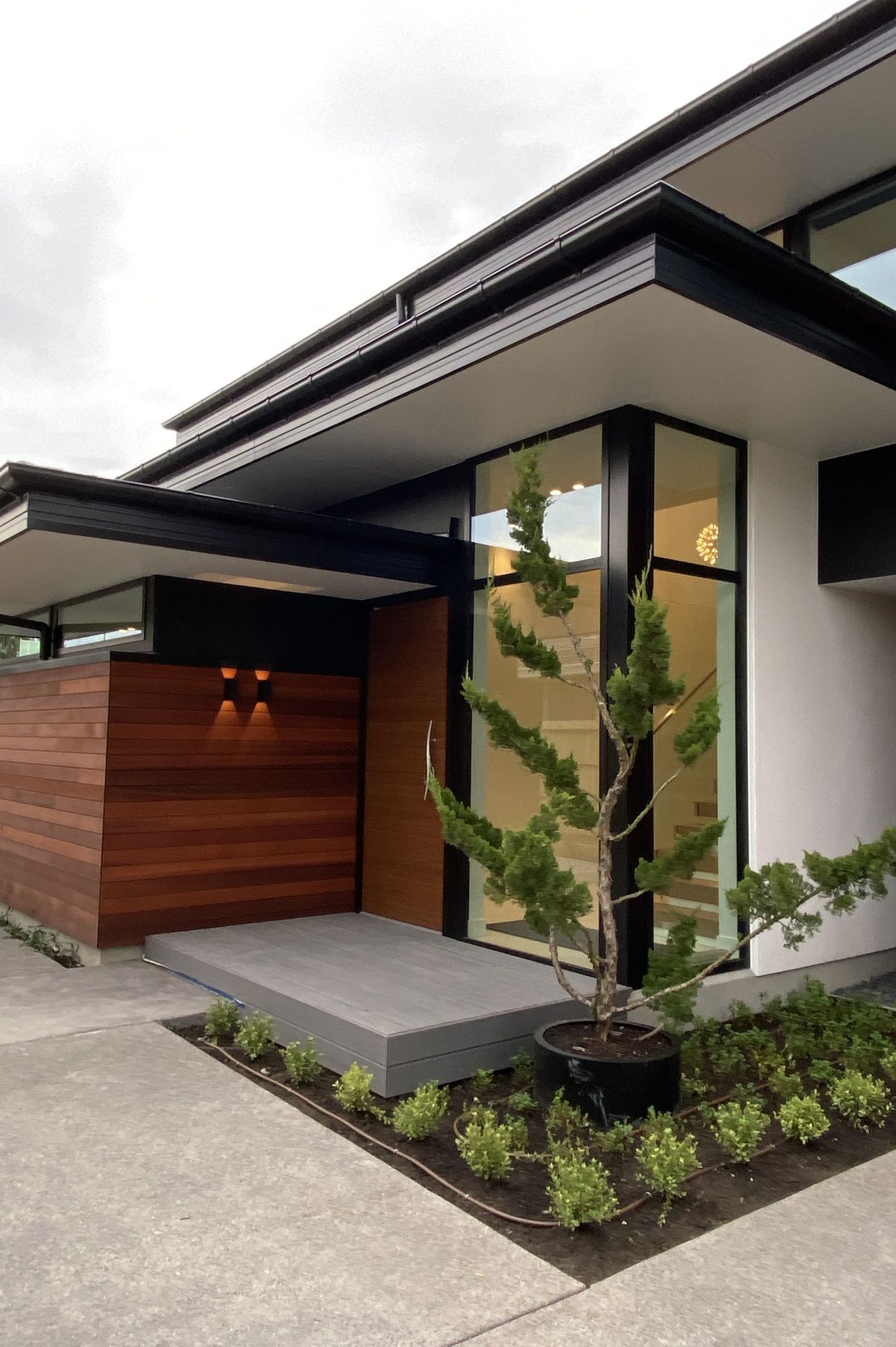 Built by DJ Hewitt Builders, this Christchurch home features RockCote Integra, horizontal cedar and schist on the chimney, and Colorsteel flashing to match the joinery.