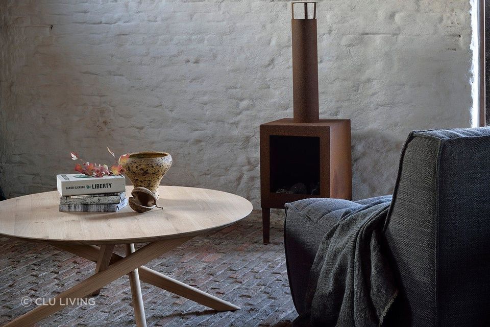 This round coffee table features a smooth surface and cross-legged design. Featured product: Mikado Round Coffee Table.