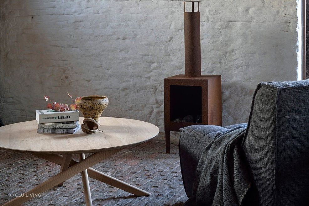 This round coffee table features a smooth surface and cross-legged design. Featured product: Mikado Round Coffee Table.