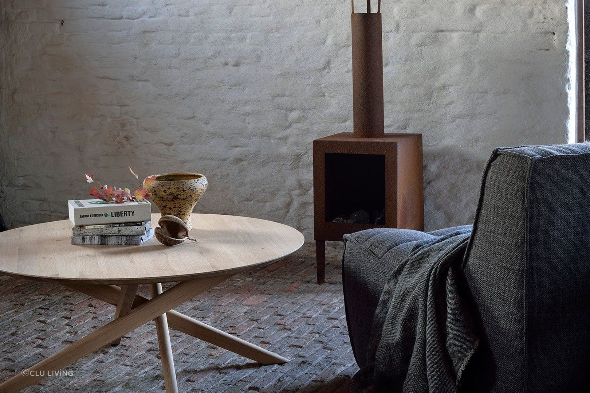 This round coffee table features a smooth surface and cross-legged design. Featured product: Mikado Round Coffee Table.
