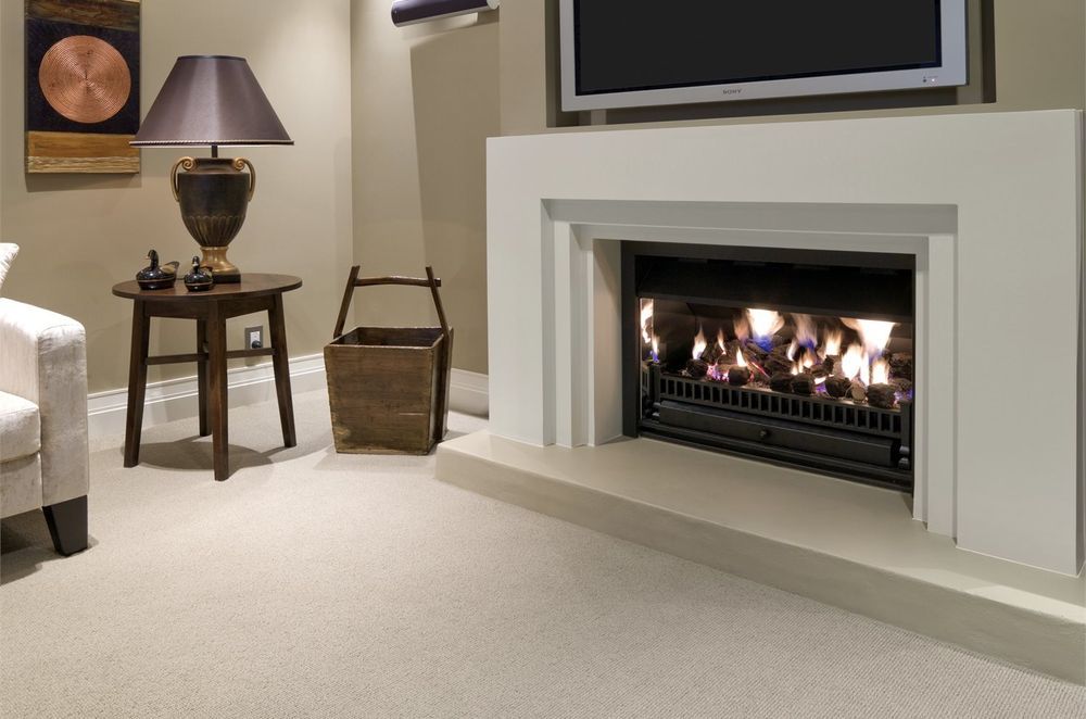 Wool carpets complement a wide range of living room designs, especially rooms where a fireplace is the focal point. Featured product: Troika Wool Carpet.
