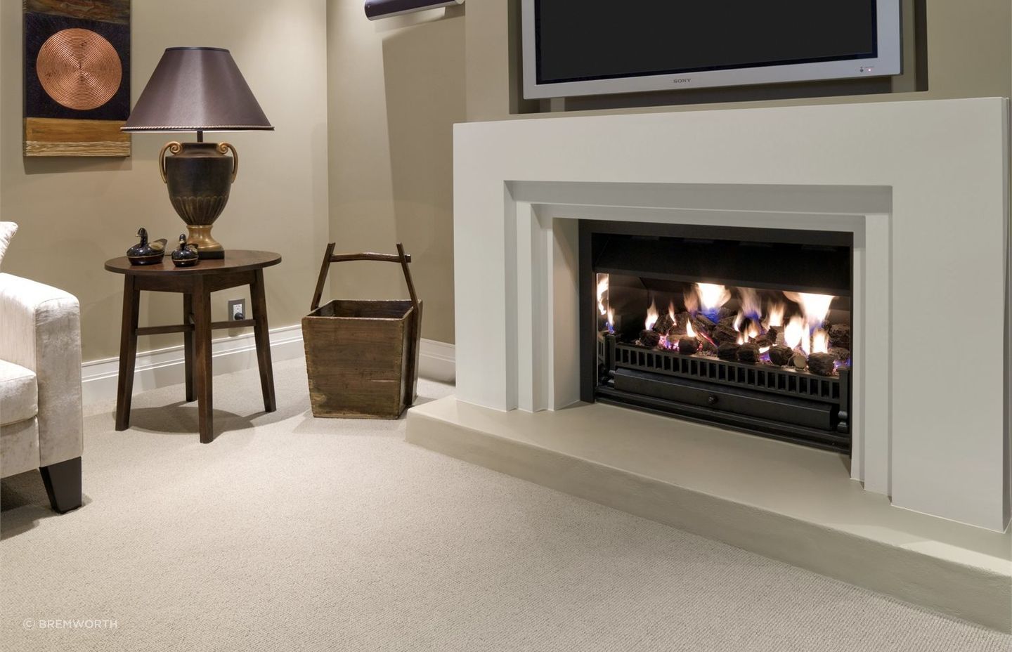Wool carpets complement a wide range of living room designs, especially rooms where a fireplace is the focal point. Featured product: Troika Wool Carpet.