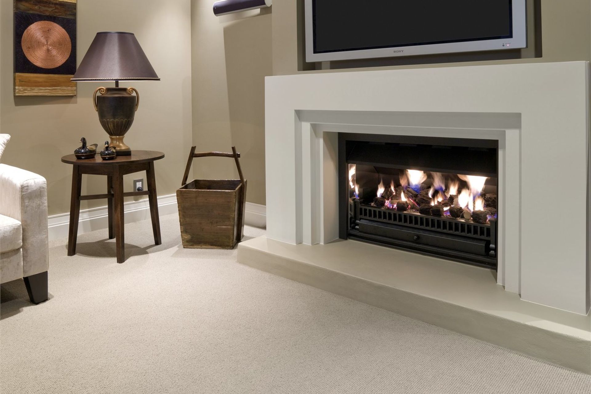 Wool carpets complement a wide range of living room designs, especially rooms where a fireplace is the focal point. Featured product: Troika Wool Carpet.