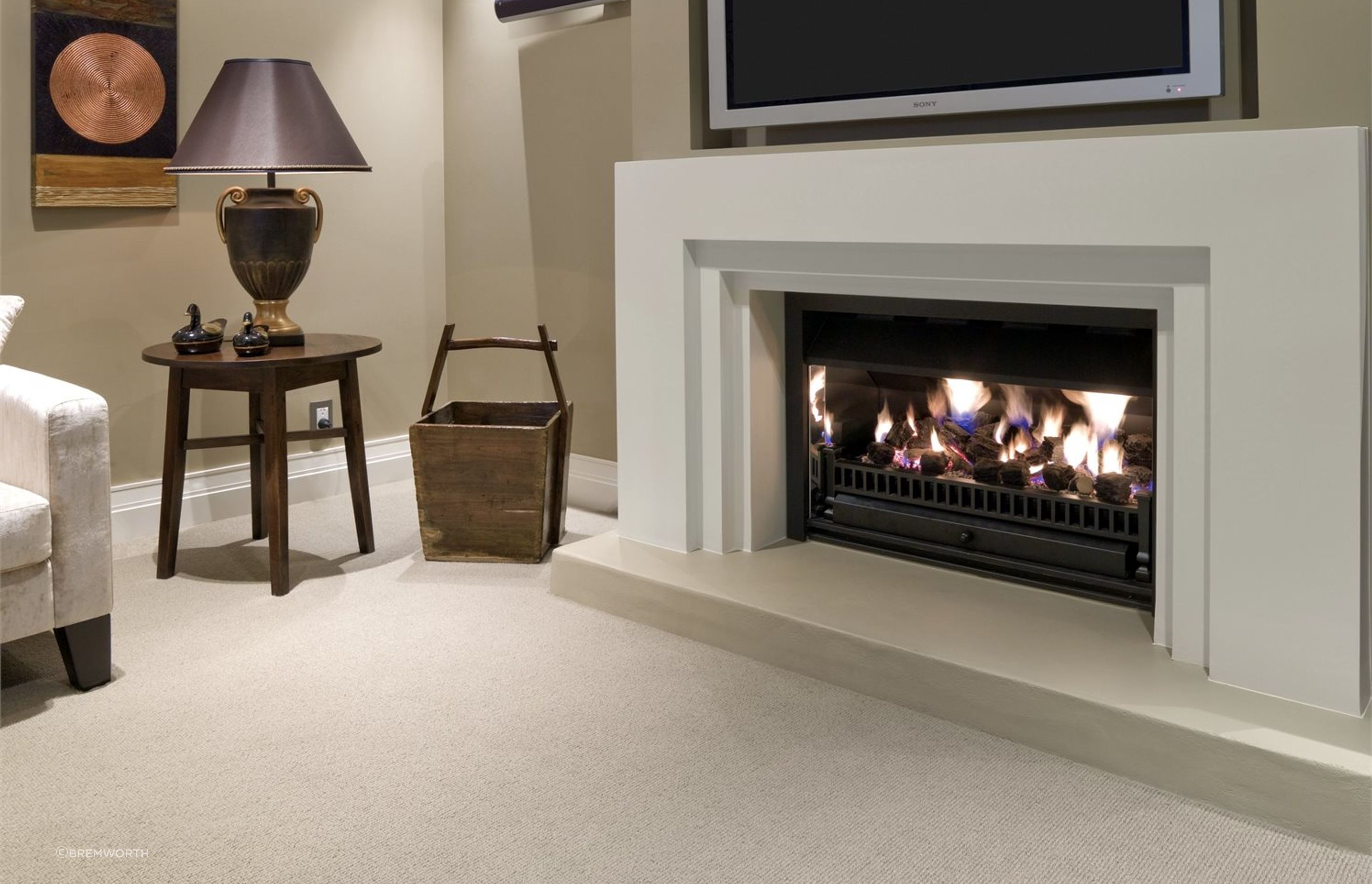 Wool carpets complement a wide range of living room designs, especially rooms where a fireplace is the focal point. Featured product: Troika Wool Carpet.
