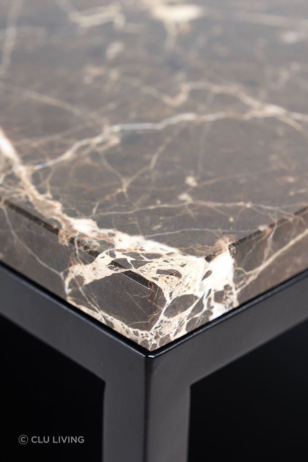 Marble is a common coffee table surface and showcases natural veining patterns.