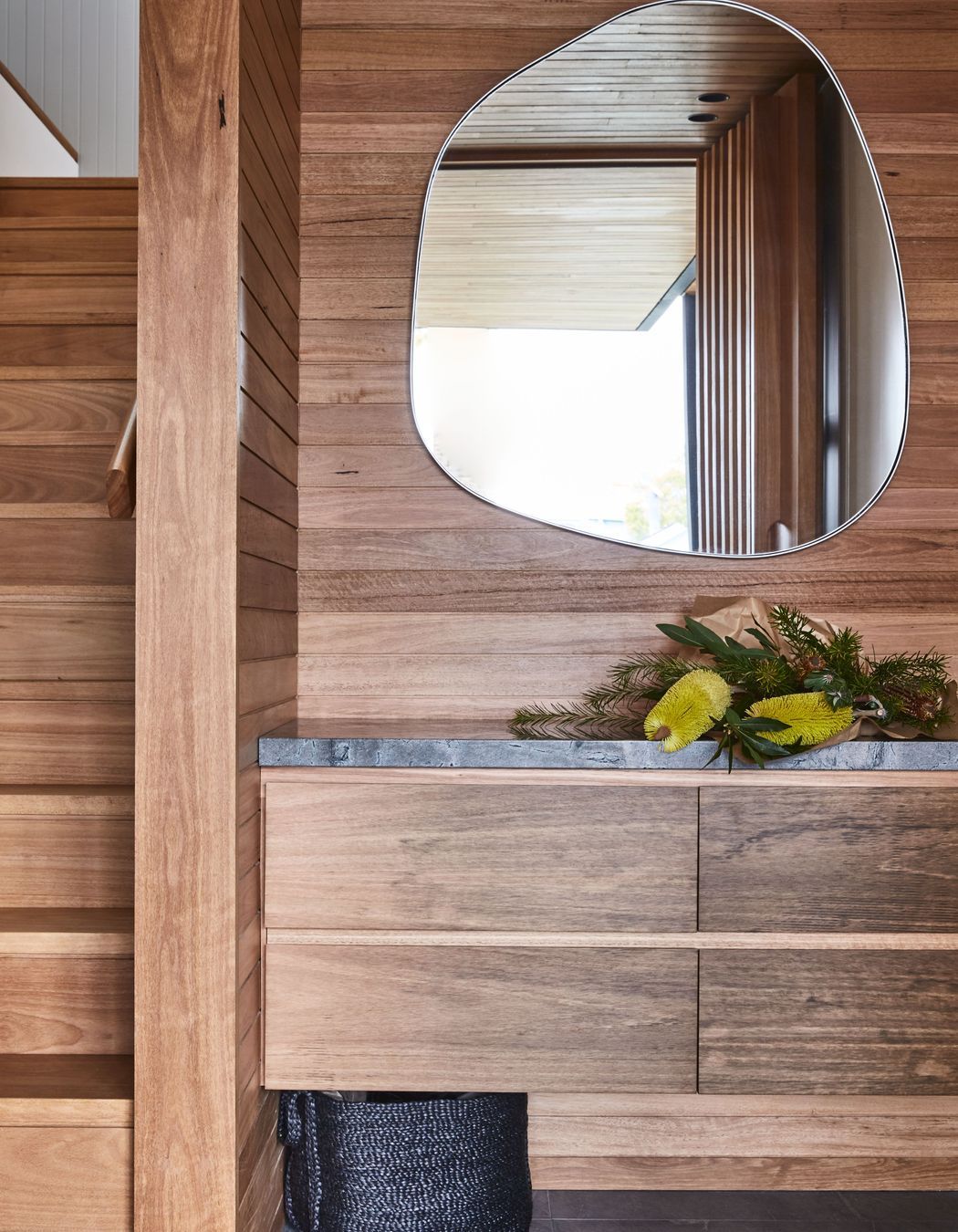 Combining textures, like the wood and stone seen here, will be key to interior design in 2024.