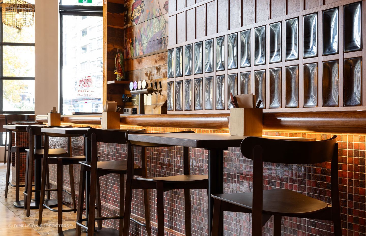 Clever under-counter lighting creates warmth and illumination in this hospitality fit-out by Dimension Shopfitters.