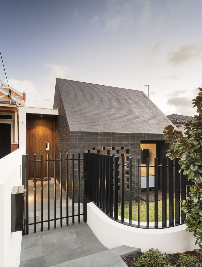 This home's side entrance is marked by a striking door that offers both privacy and intrigue. Featured project: Alma by Weststyle