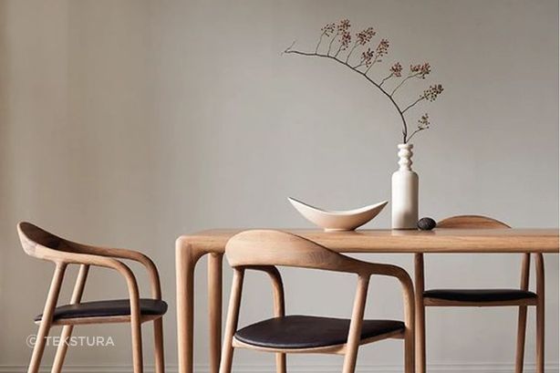 A decorative vase placed on a dining room table is a functional centrepiece.