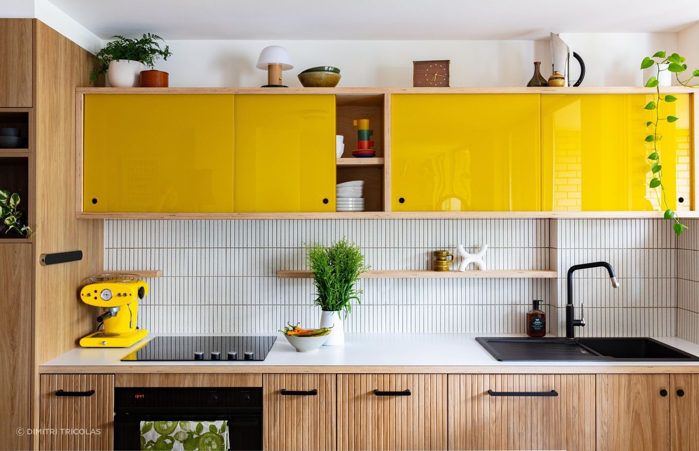 A powerful injection of pop with yellow glass sliding doors in the Glebe Apartment kitchen. | Photography: Dimitri Tricolas