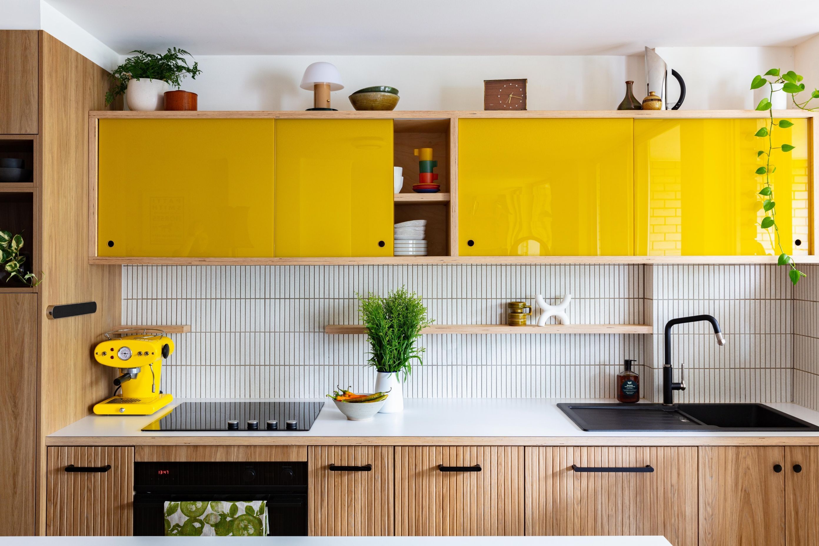 A powerful injection of pop with yellow glass sliding doors in the Glebe Apartment kitchen. | Photography: Dimitri Tricolas