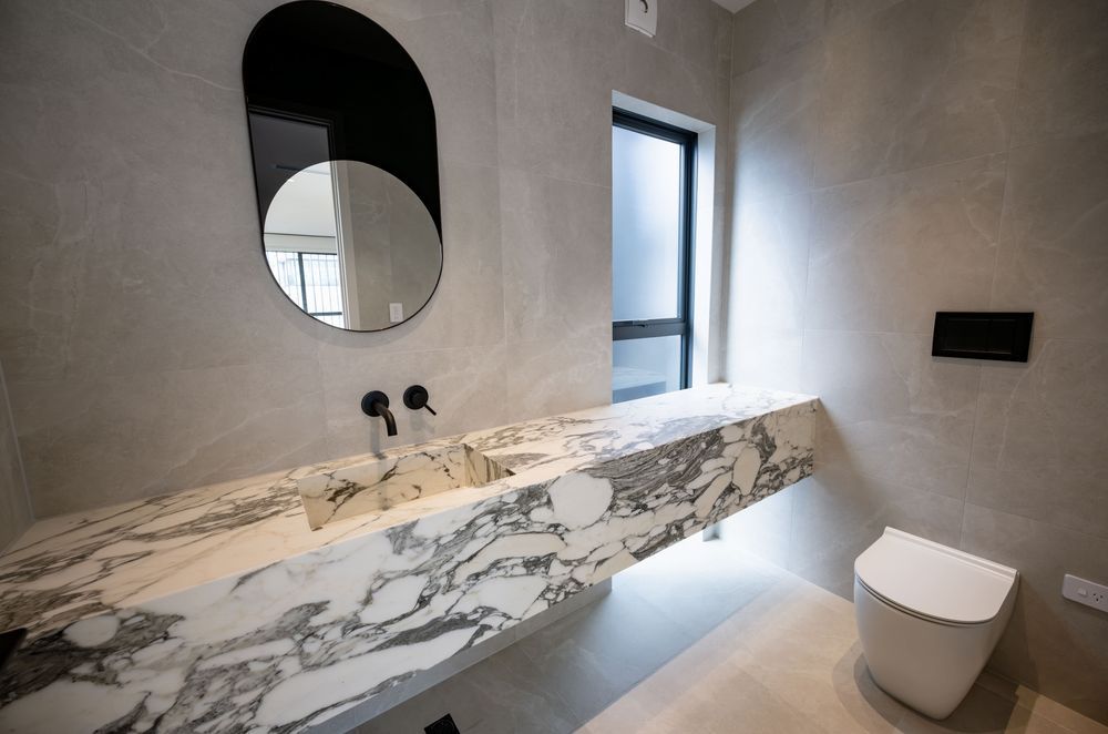 A stunning wall hung vanity by Mosman Interiors featuring exquisite Calacatta Marble.