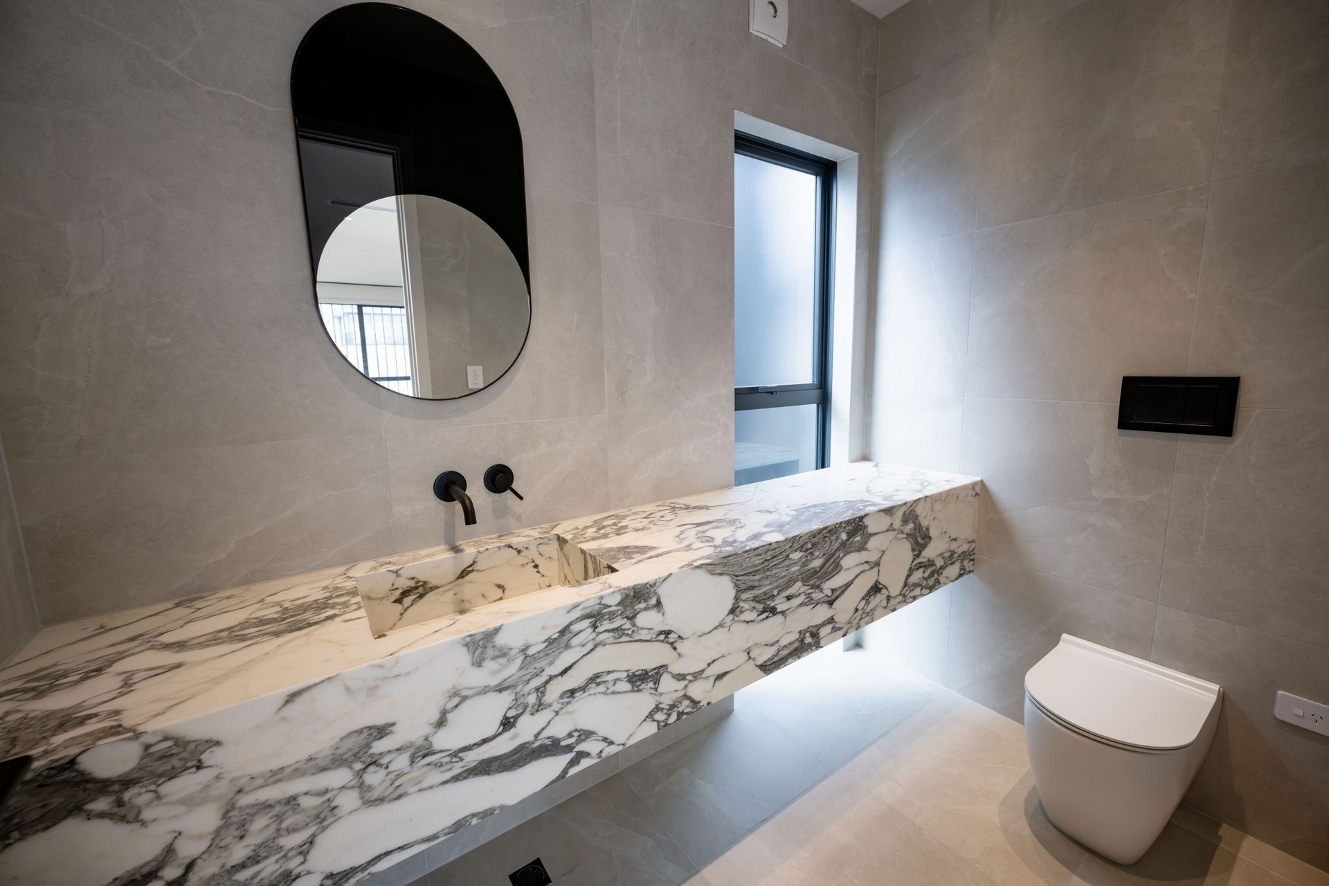 A stunning wall hung vanity by Mosman Interiors featuring exquisite Calacatta Marble.