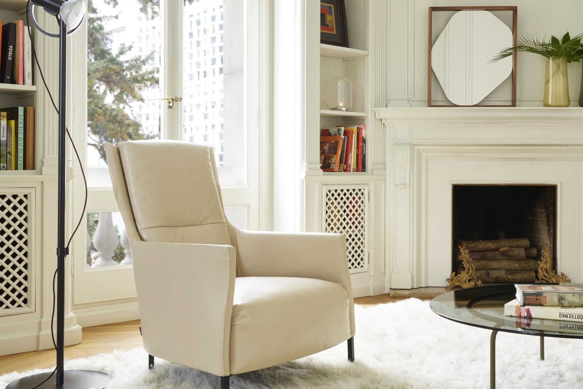The unique Belize Mirror by Kensaku Oshiro positioned to amplify the warm shimmer of the fireplace below.