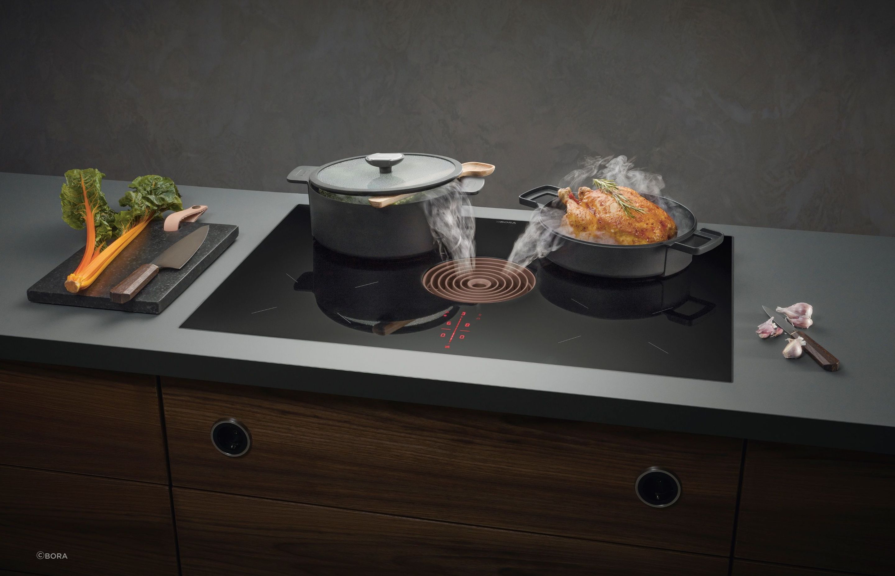 The Bora Pure Combined Cooktop and Extractor is a modern and elegant solution that sits flush against a benchtop.