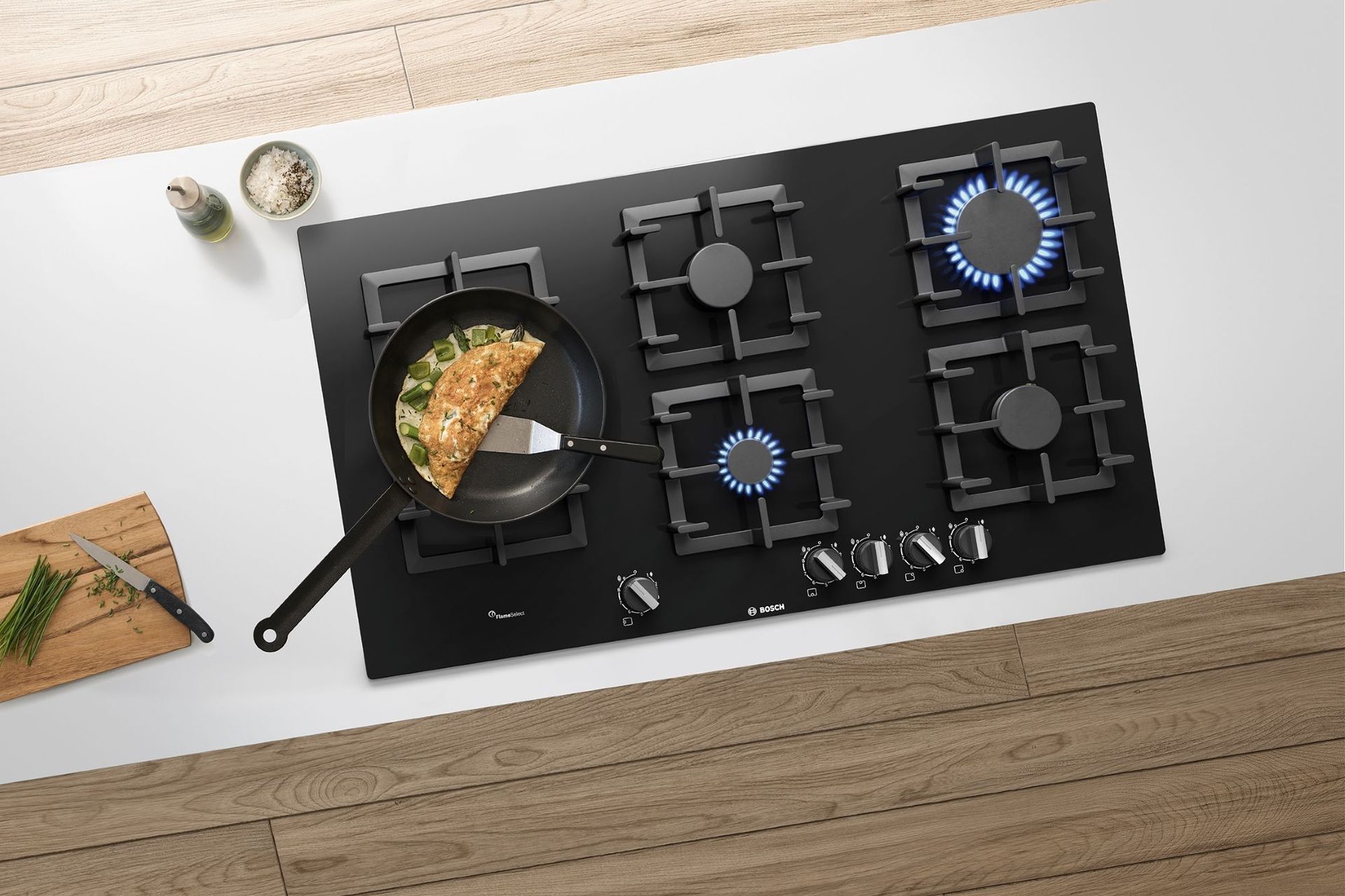 The BOSCH Series 6 Black Tempered Glass Gas Cooktop boasts a powerful 15 Mj/h Wok Burner, perfect for stir-frying.