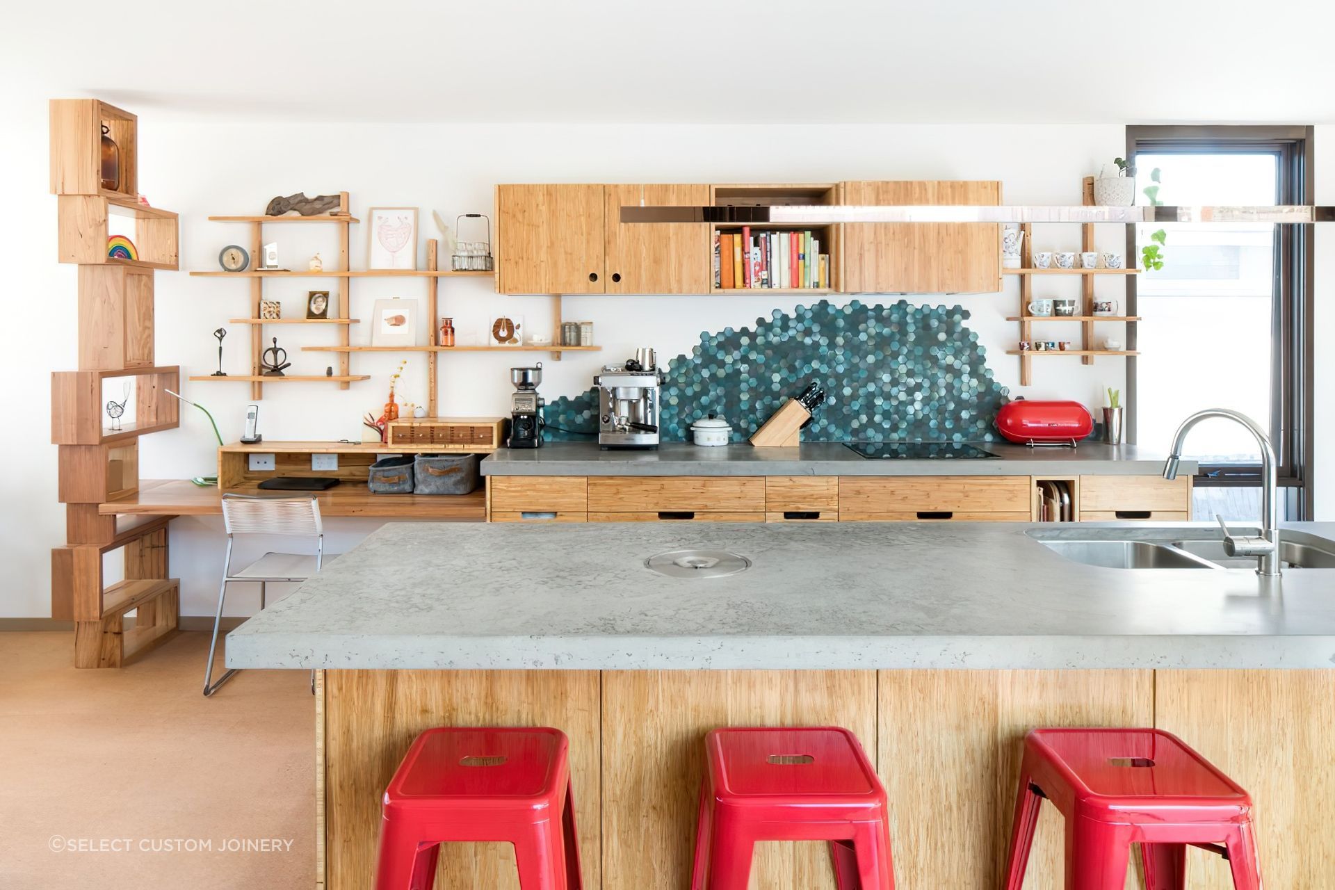 These natural grey concrete benchtops contrast wonderfully with bamboo panelling in this stylish Melbourne kitchen by Select Custom Joinery.