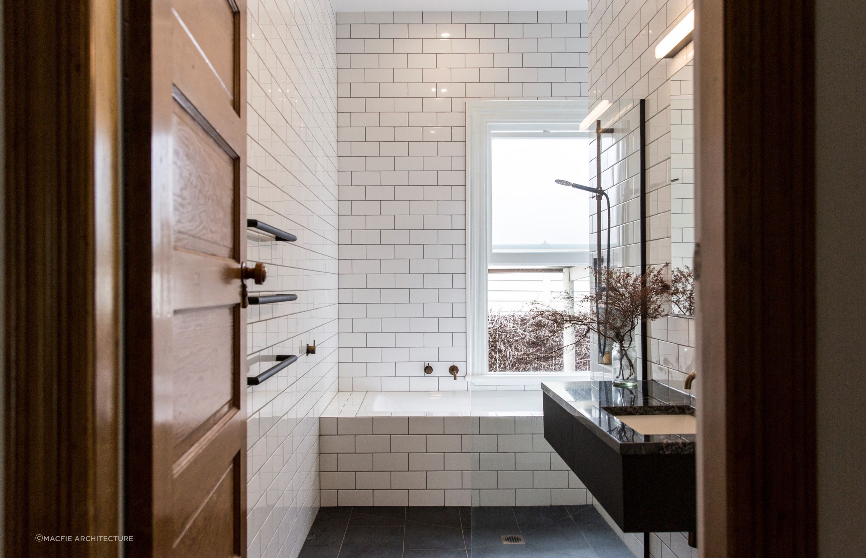Beautiful tile details flowing seamlessly over the edge of the bath in this bathroom in Sandringham.