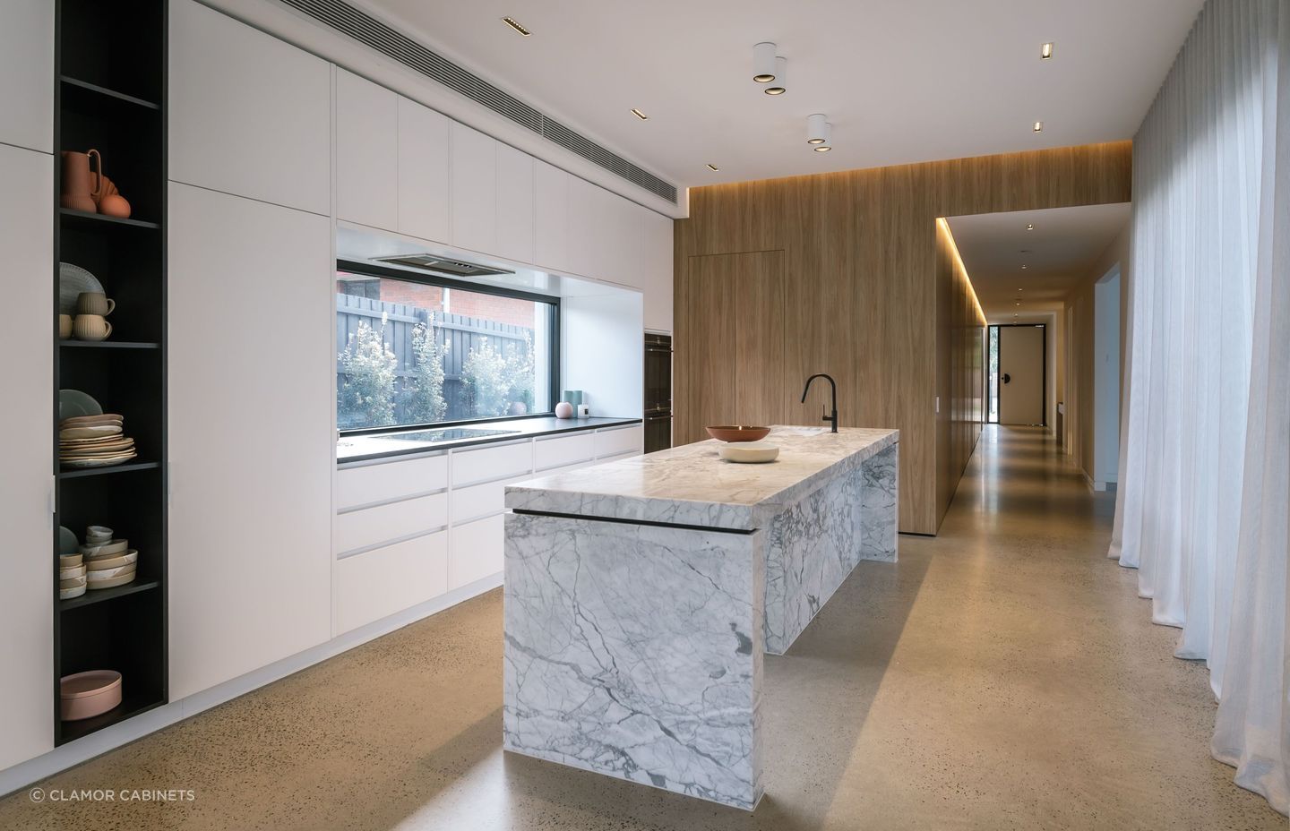 Sleek, integrated cabinets offer crisp lines and seamless aesthetics in this kitchen in Bonbeach. | Photography: Janis House Photography