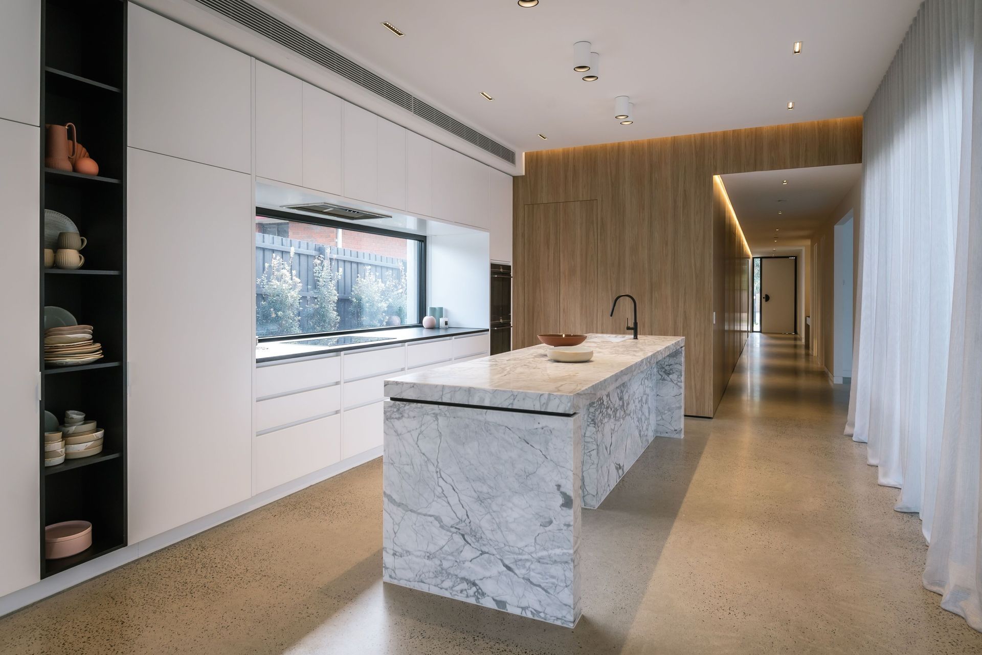 Sleek, integrated cabinets offer crisp lines and seamless aesthetics in this kitchen in Bonbeach. | Photography: Janis House Photography