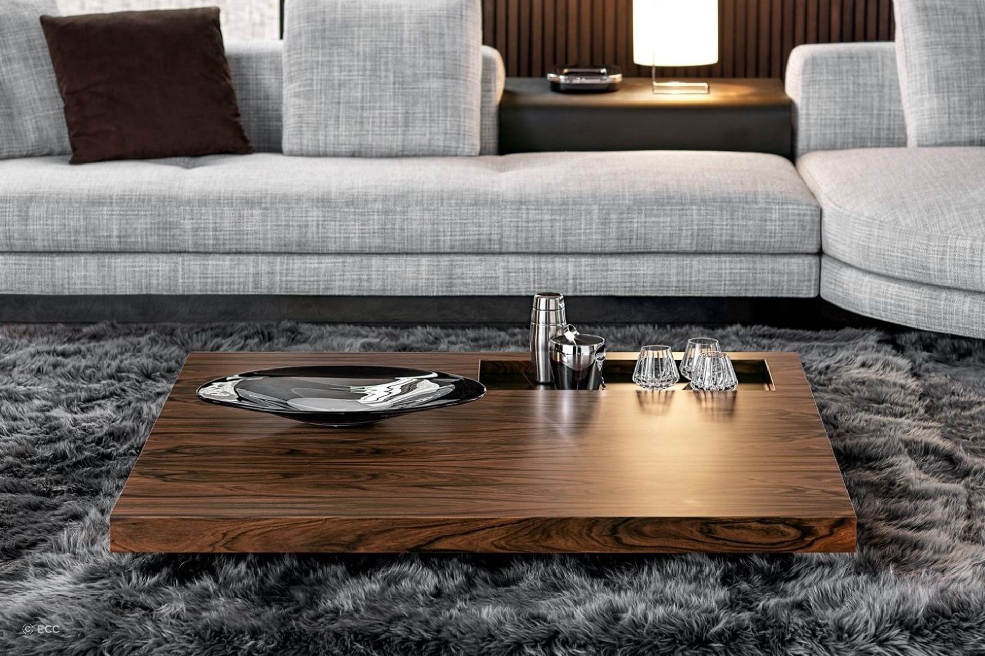 Glass and tableware can be permanent decor items for your coffee table, readily available when you need them, as seen here on the sophisticated Boteco Coffee Table by Minotti.