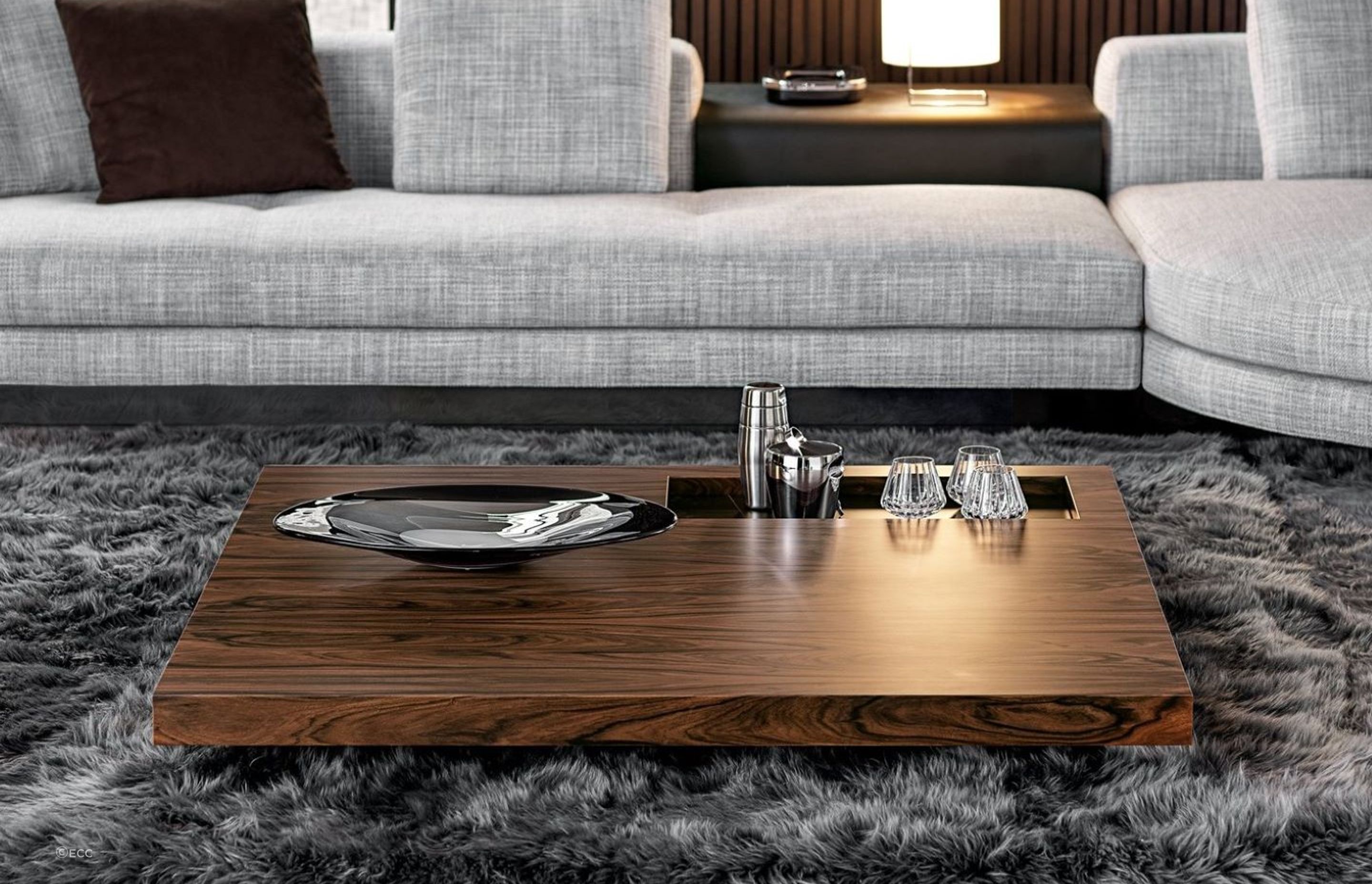 Glass and tableware can be permanent decor items for your coffee table, readily available when you need them, as seen here on the sophisticated Boteco Coffee Table by Minotti.