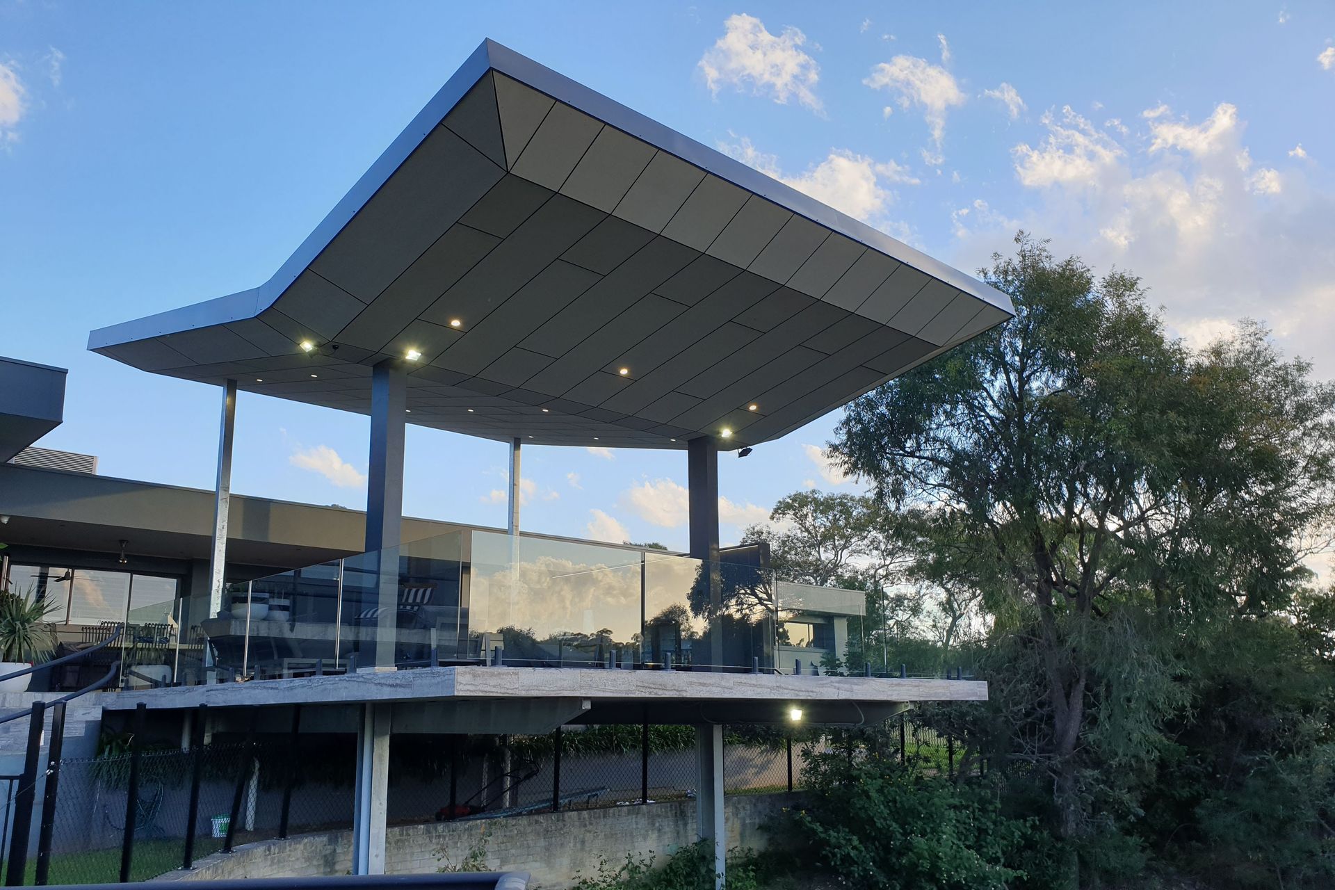 A butterfly roof, marked by its distinctive inverted V shape allows natural light to penetrate an area. Featured project: Annandale Patio