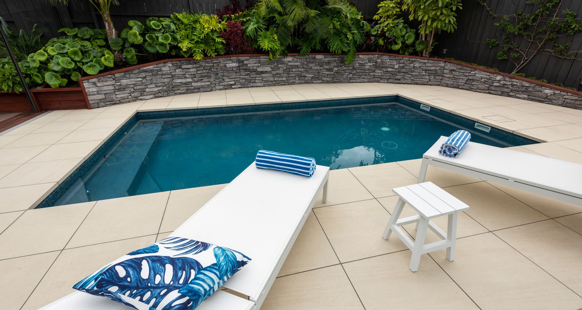 The pool renovation project began with an existing pool that was becoming troublesome with leaks and ongoing maintenance issues. The homeowner had recently renovated their 1970s home, and the outdoor living area was in need of a revamp also. It was decided to remove the existing liner pool and install a shotcrete pool within the same footprint. The existing 'kidney' shaped pool was 'squared up' and the pool surrounds were replaced along with pool fencing replaced and a brand new, modern pool area was achieved, all within the same footprint.
This project won Gold for the Pool Renovation Category at the SPASA NZ Awards of Excellence 2022.