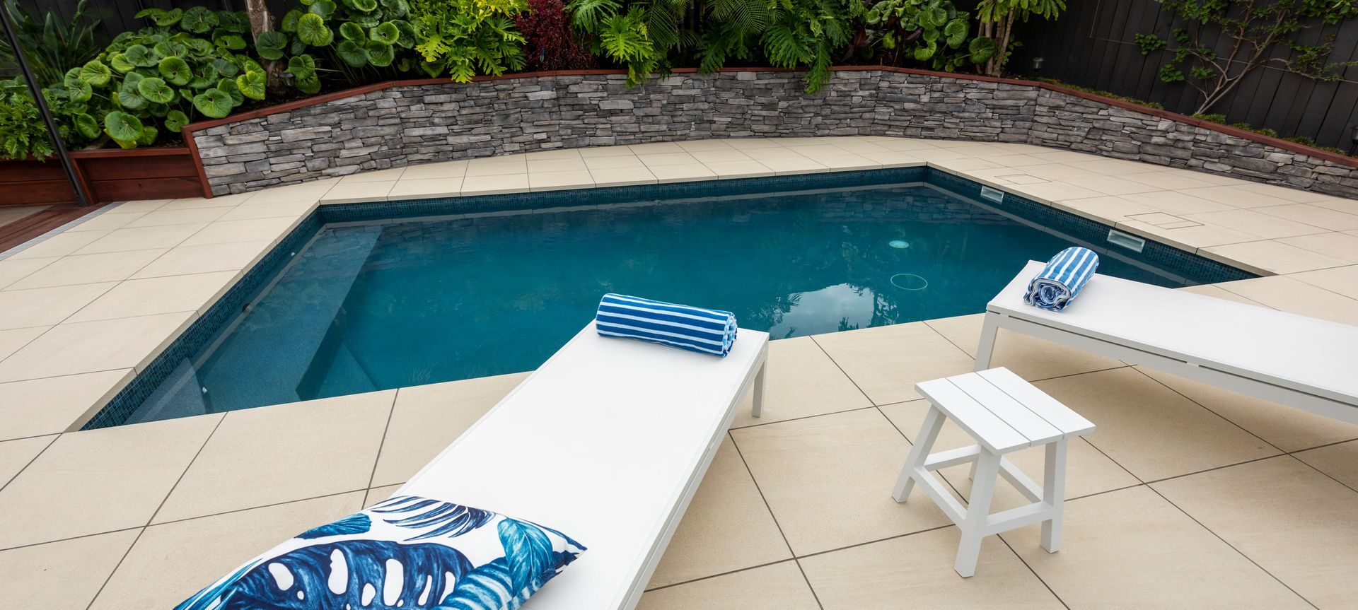 The pool renovation project began with an existing pool that was becoming troublesome with leaks and ongoing maintenance issues. The homeowner had recently renovated their 1970s home, and the outdoor living area was in need of a revamp also. It was decided to remove the existing liner pool and install a shotcrete pool within the same footprint. The existing 'kidney' shaped pool was 'squared up' and the pool surrounds were replaced along with pool fencing replaced and a brand  new, modern pool area was achieved, all within the same footprint.
This project won Gold for the Pool Renovation Category at the SPASA NZ Awards of Excellence 2022.