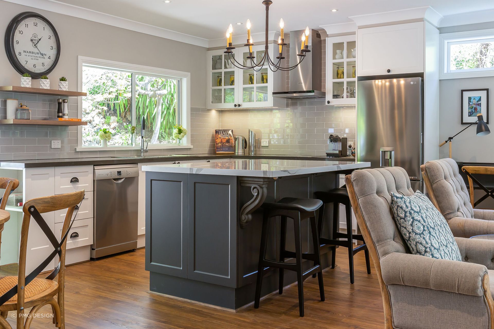 A Hamptons Style kitchen with a graceful iron chandelier.