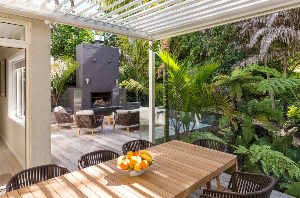 A well-designed outdoor living space, like this one in Remuera, allows you to get the most out of it, even in dense, lush settings like these.