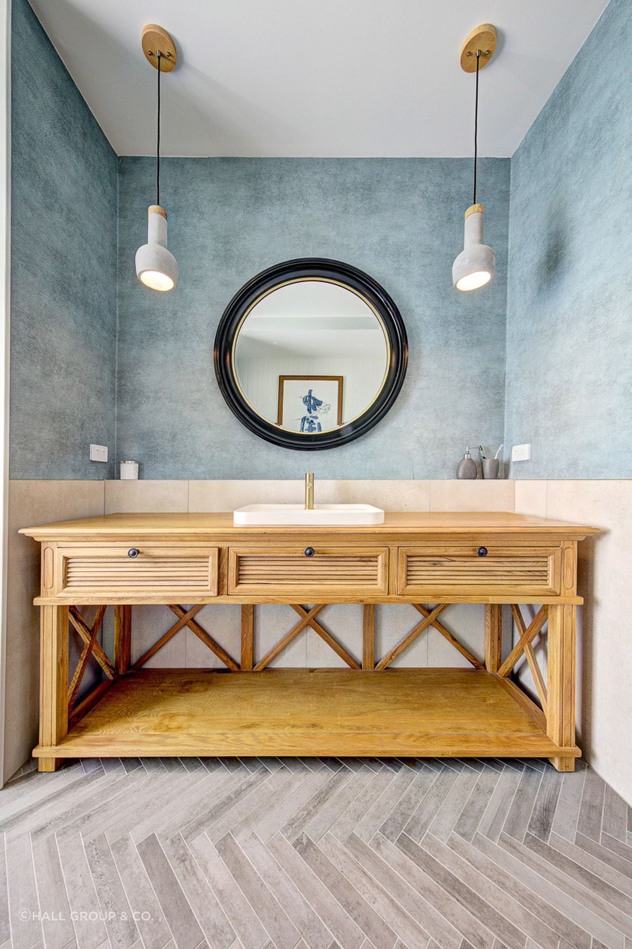 Interior design excellence shines through with a coastal feature wall, infusing the bathroom with the tranquil vibes of the shore.