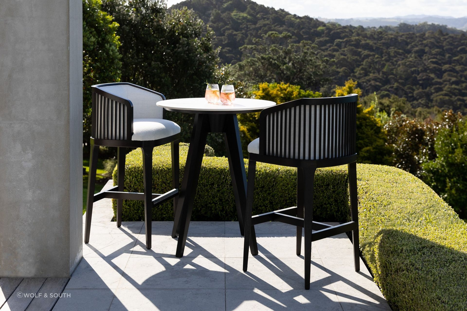 The Largo Bar Stool by Coco Wolf from Wolf &amp; South features an upholstered seat and backrest.