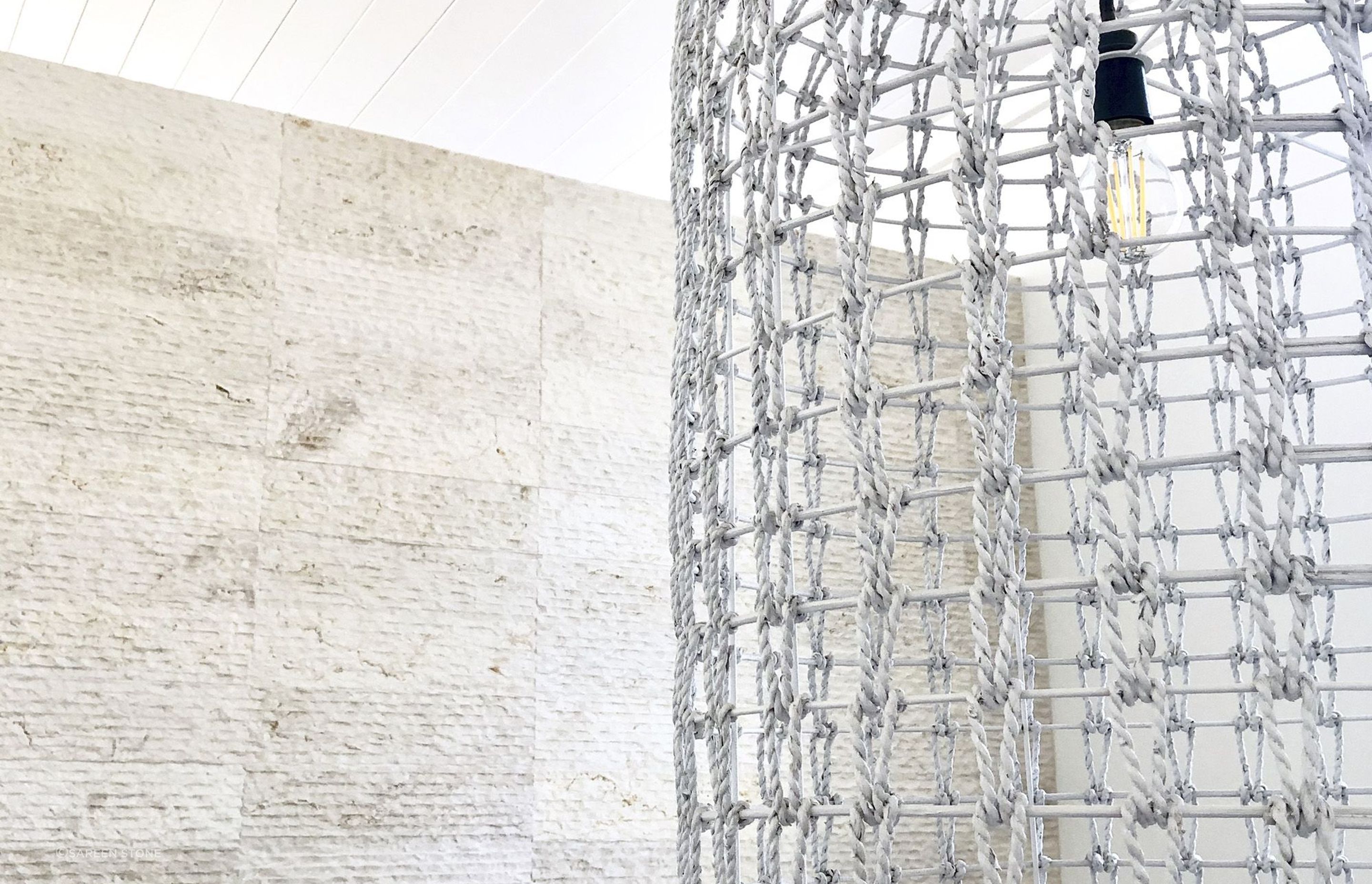 Cream wall cladding in action: modern aesthetic meets warm, soft-textured Crema Alpenia Limestone for an effortlessly contemporary look. Featured product: Cascade Cream Wall Cladding.
