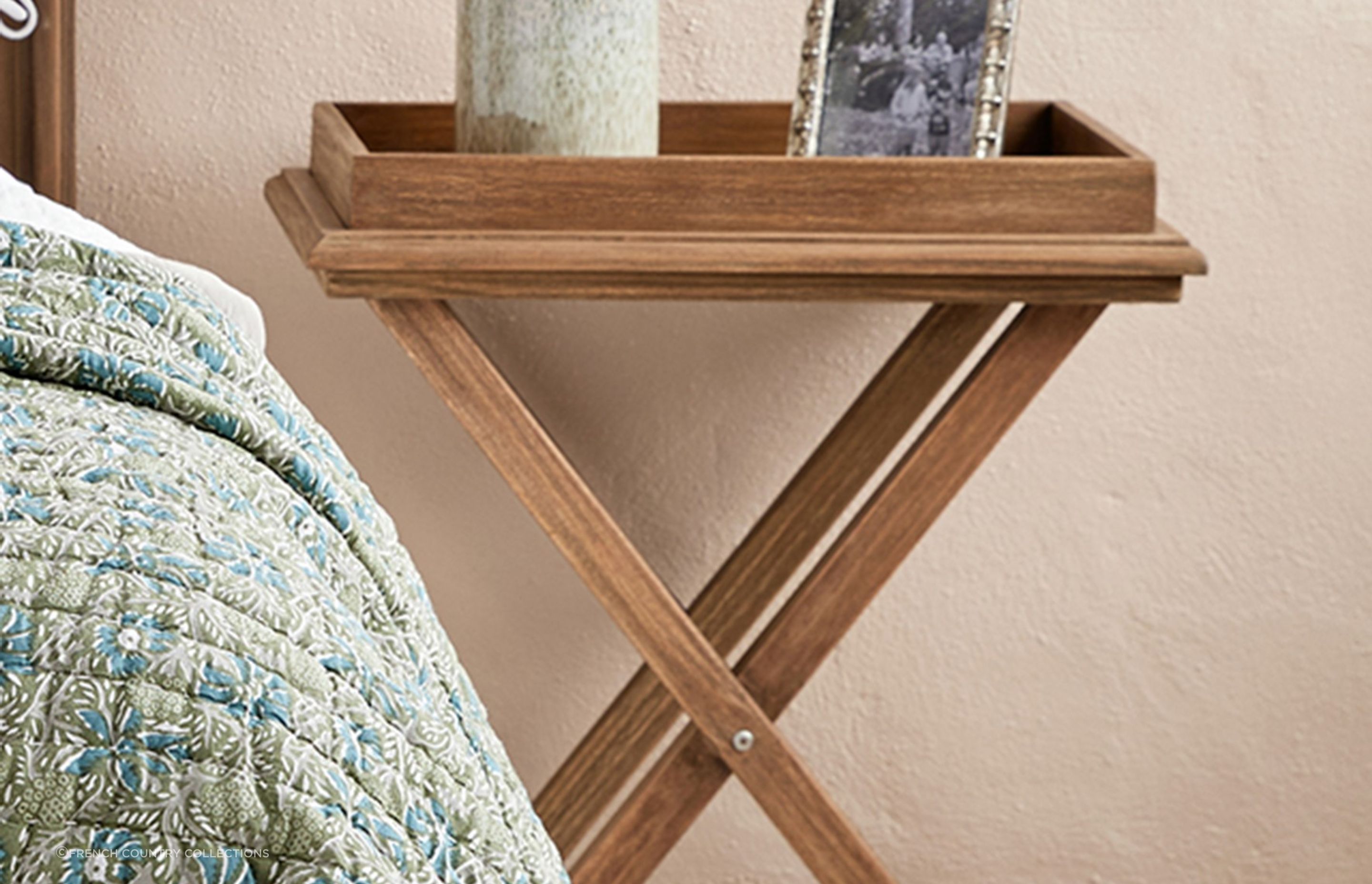 The rustic charm of the Cross Leg Tray Table makes it perfect for a relaxed setting.