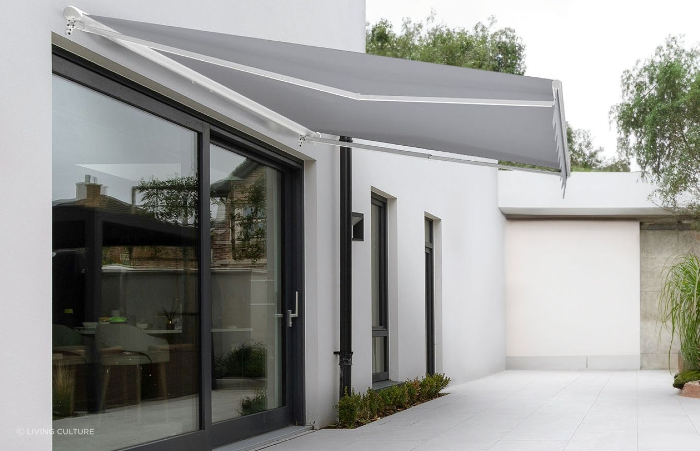 A stylish Custom Retractable Awning from Living Culture that completely frees up floor space while offering shade.