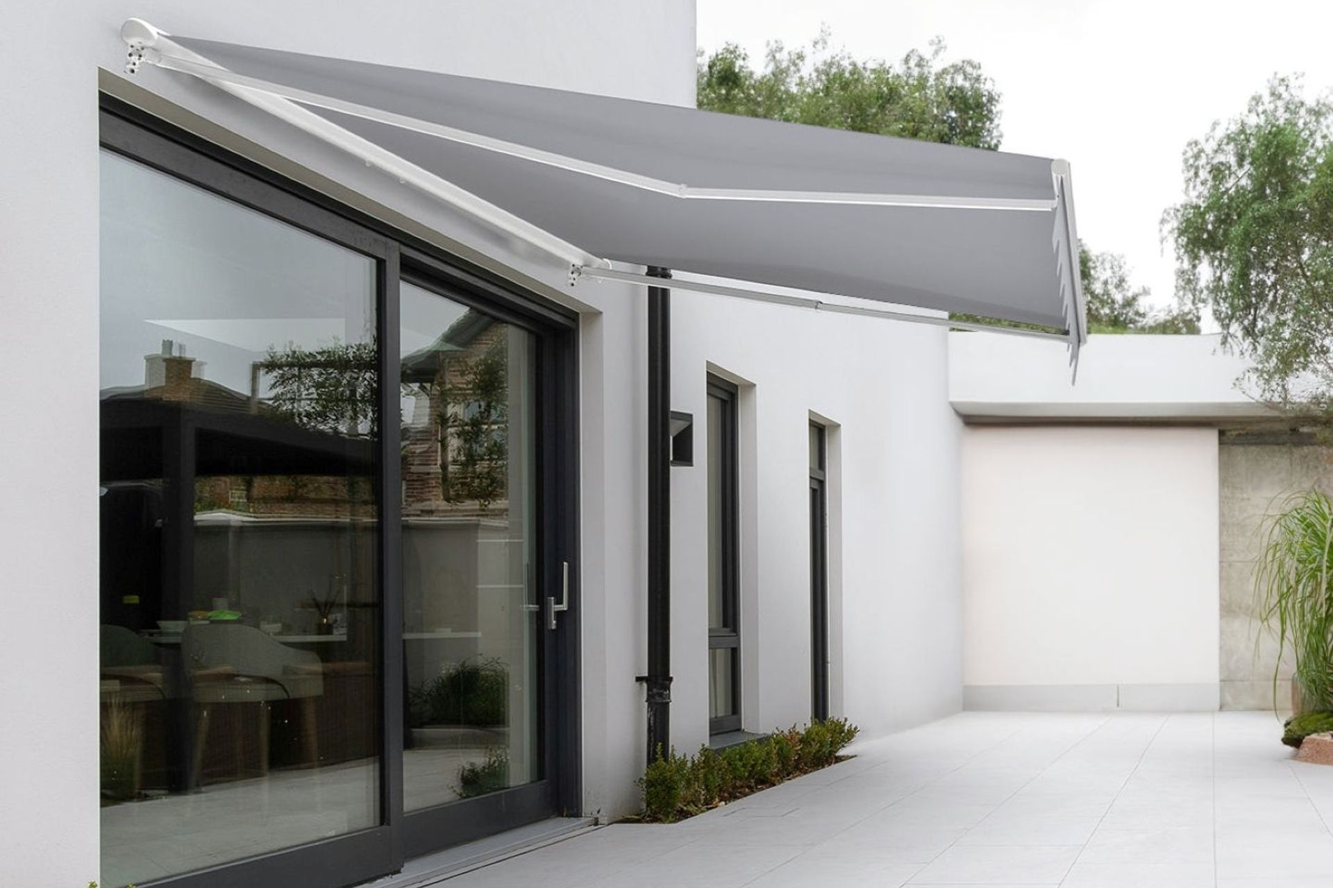 A stylish Custom Retractable Awning from Living Culture that completely frees up floor space while offering shade.