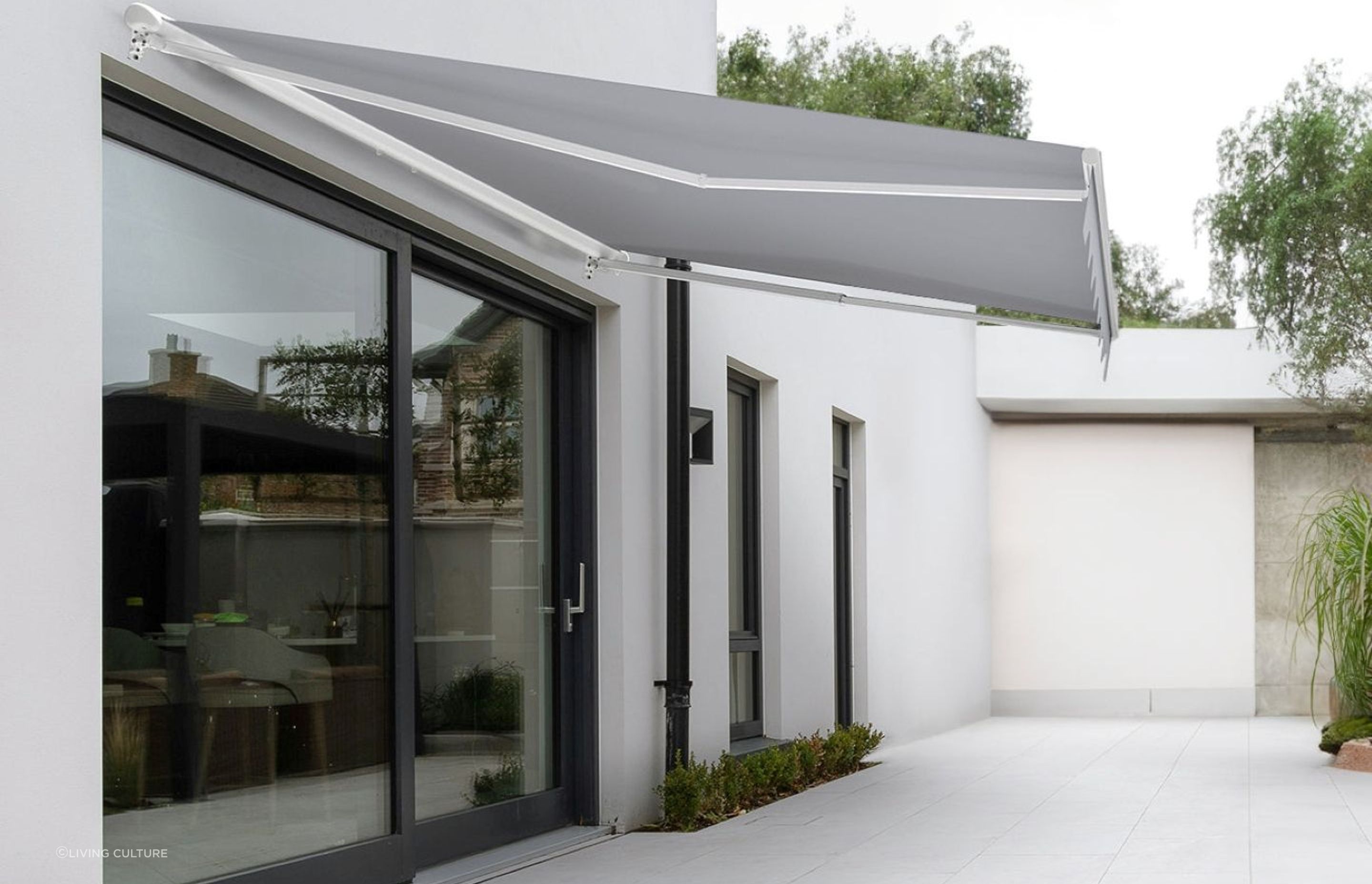 A stylish Custom Retractable Awning from Living Culture that completely frees up floor space while offering shade.