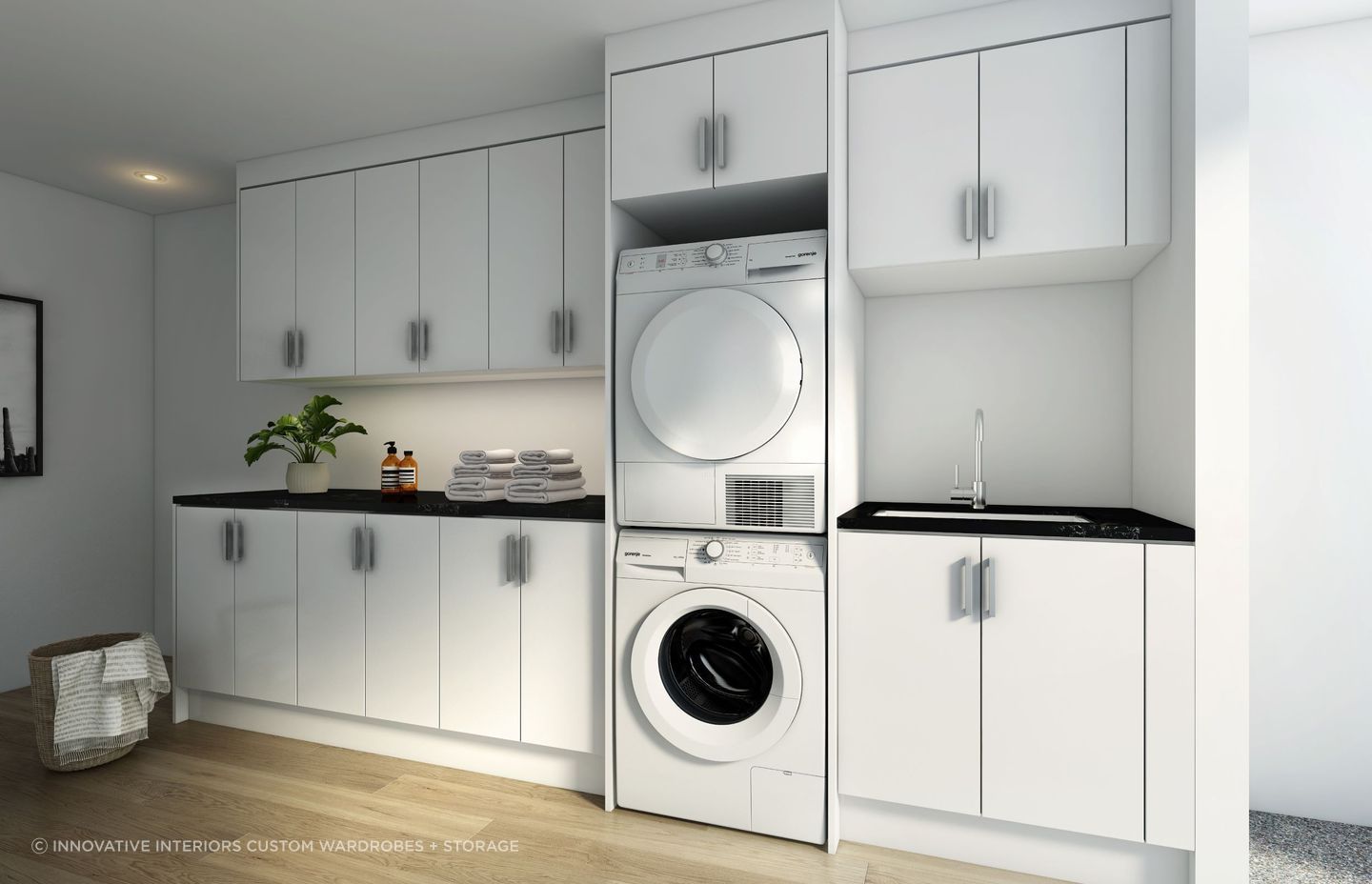A stylish custom laundry storage solution featuring a stacker for the washer and dryer, a great option for saving space.