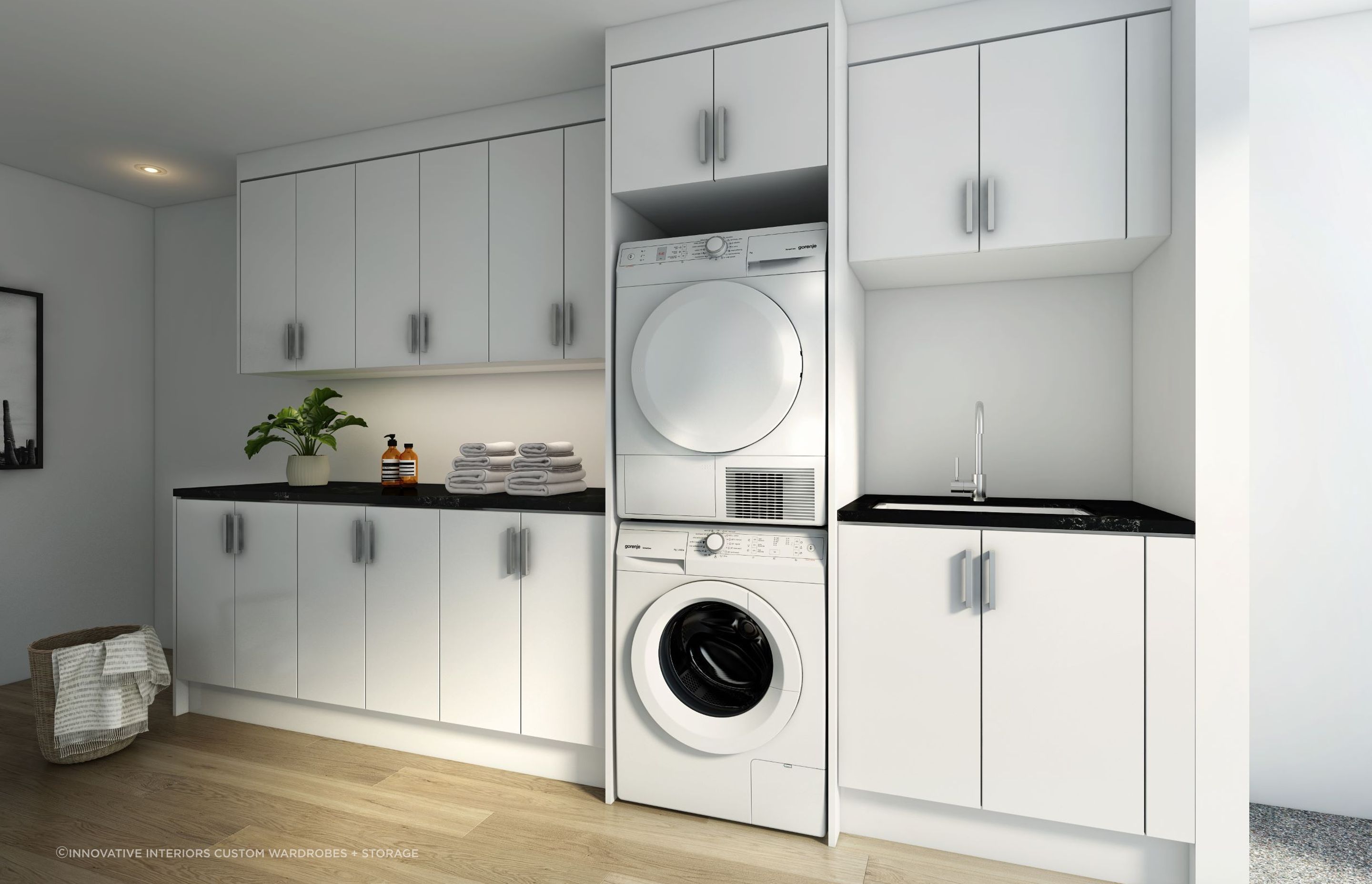 A stylish custom laundry storage solution featuring a stacker for the washer and dryer, a great option for saving space.