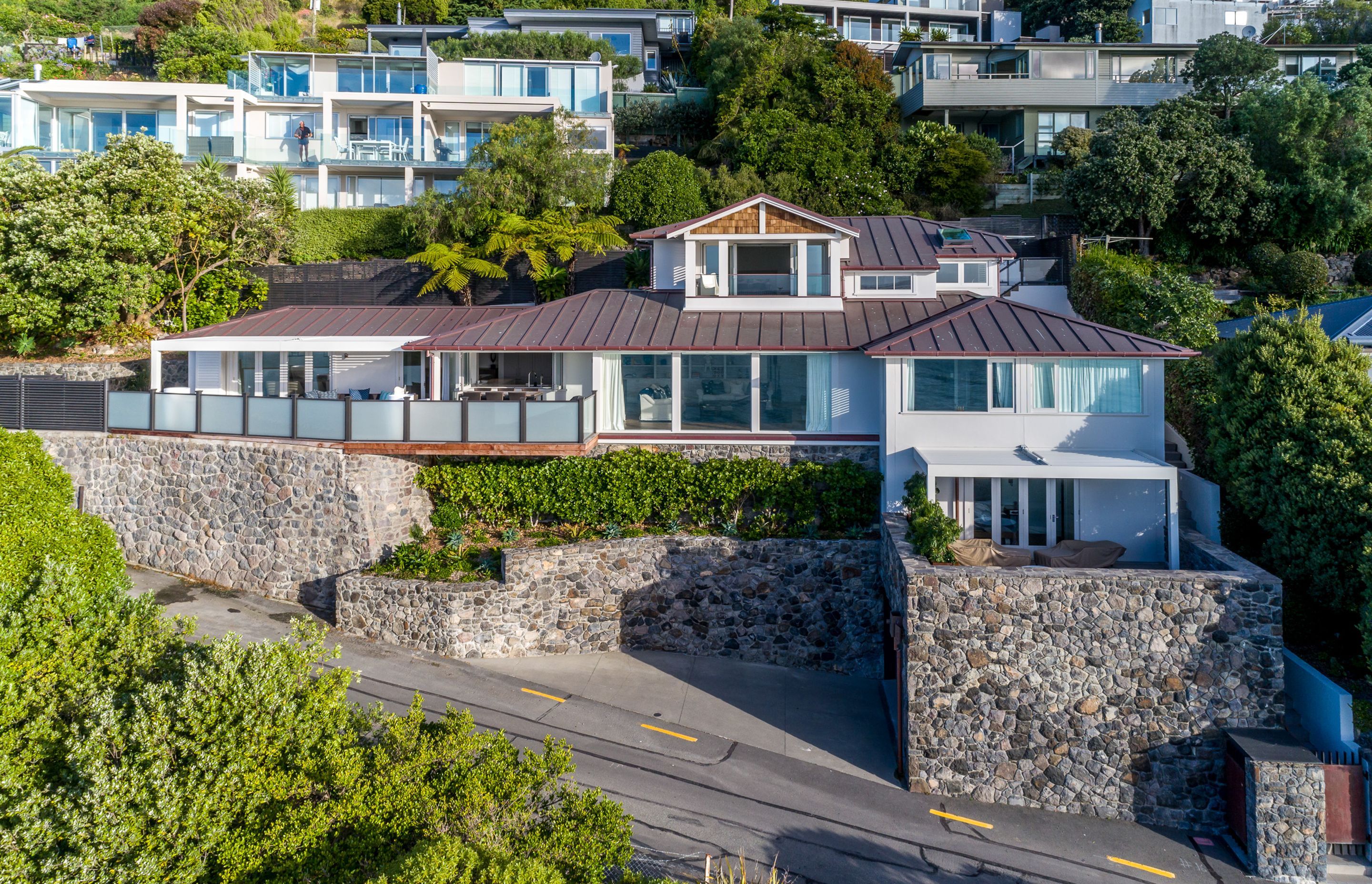 Stone walls  make a feature out of the extensive retaining required for this hillside build.