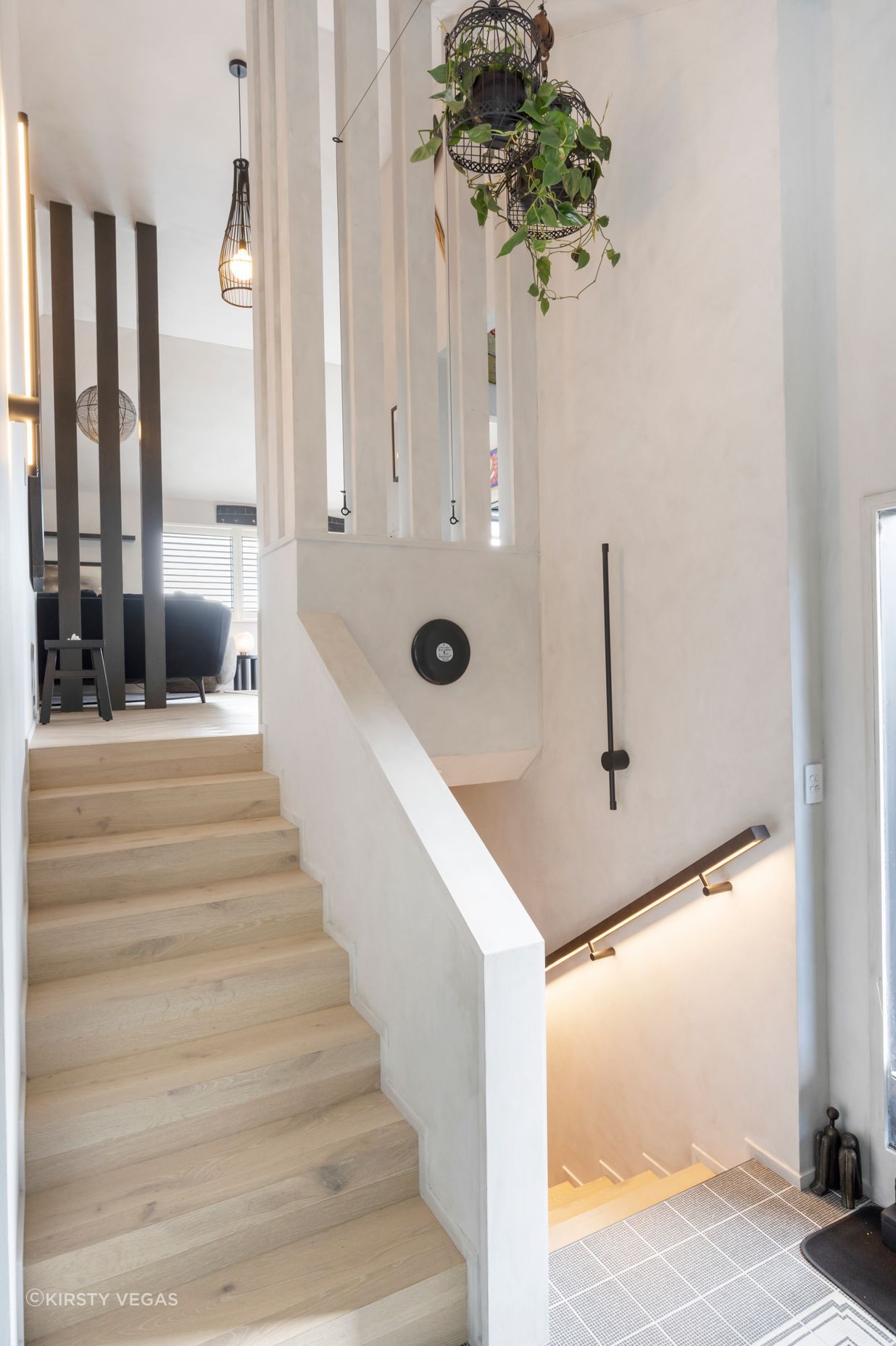 Vintage birdcages and pulleys paired with a custom leather backlit stairwell bannister.