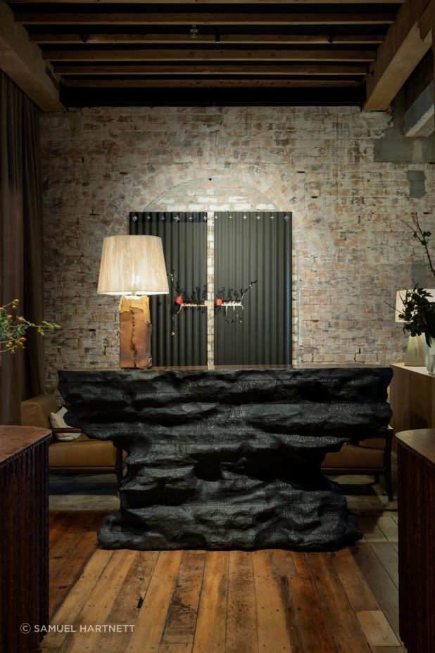 Soft lamp lighting creates a cosy, warm environment for guests visiting The Libraries bar at Hotel Britomart.