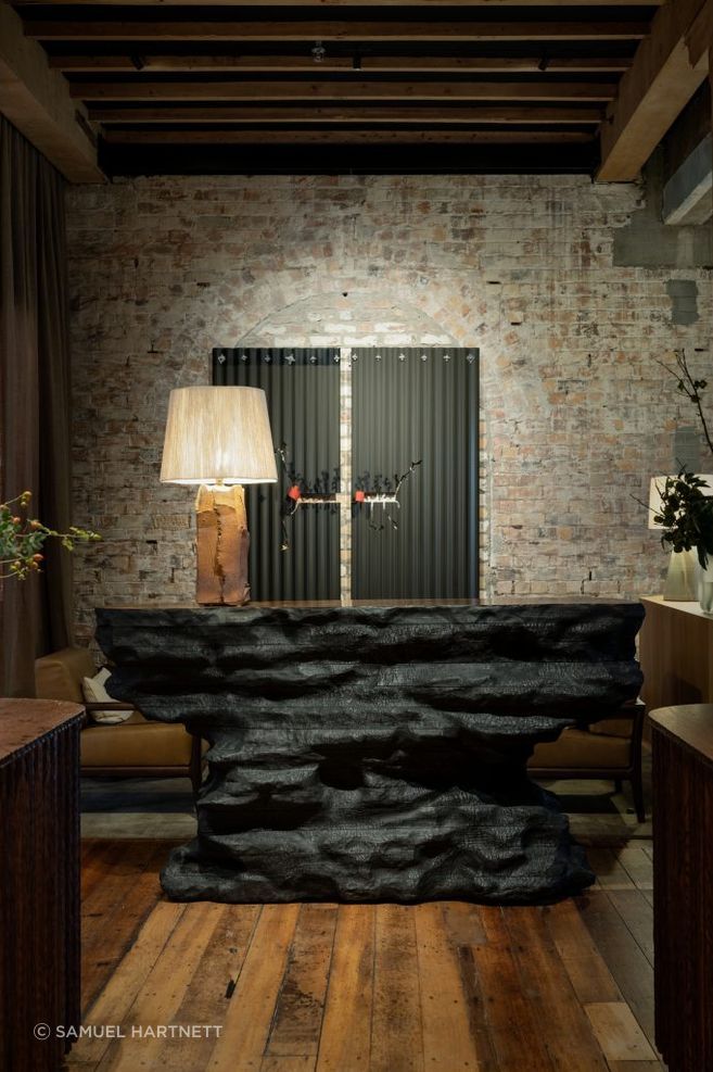 Soft lamp lighting creates a cosy, warm environment for guests visiting The Libraries bar at Hotel Britomart.