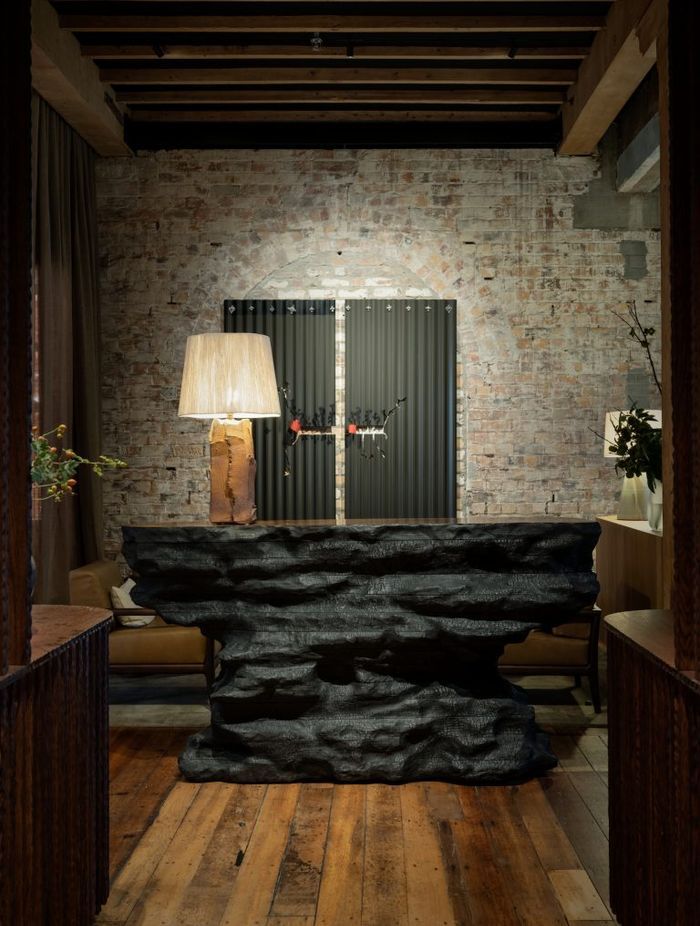 Soft lamp lighting creates a cosy, warm environment for guests visiting The Libraries bar at Hotel Britomart.