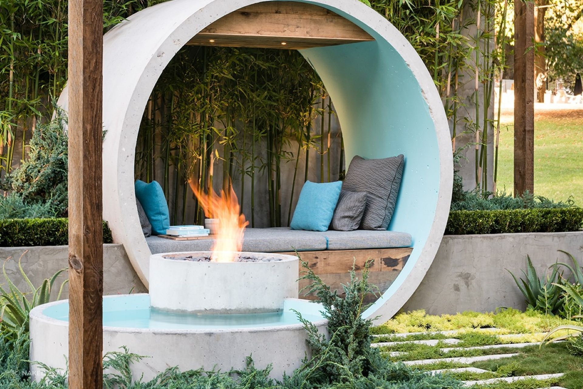 Incorporating your fire pit into a water feature, stylishly done here with the EcoSmart AB8 Ethanol Fireplace, can result in a stunning focal point for your backyard.