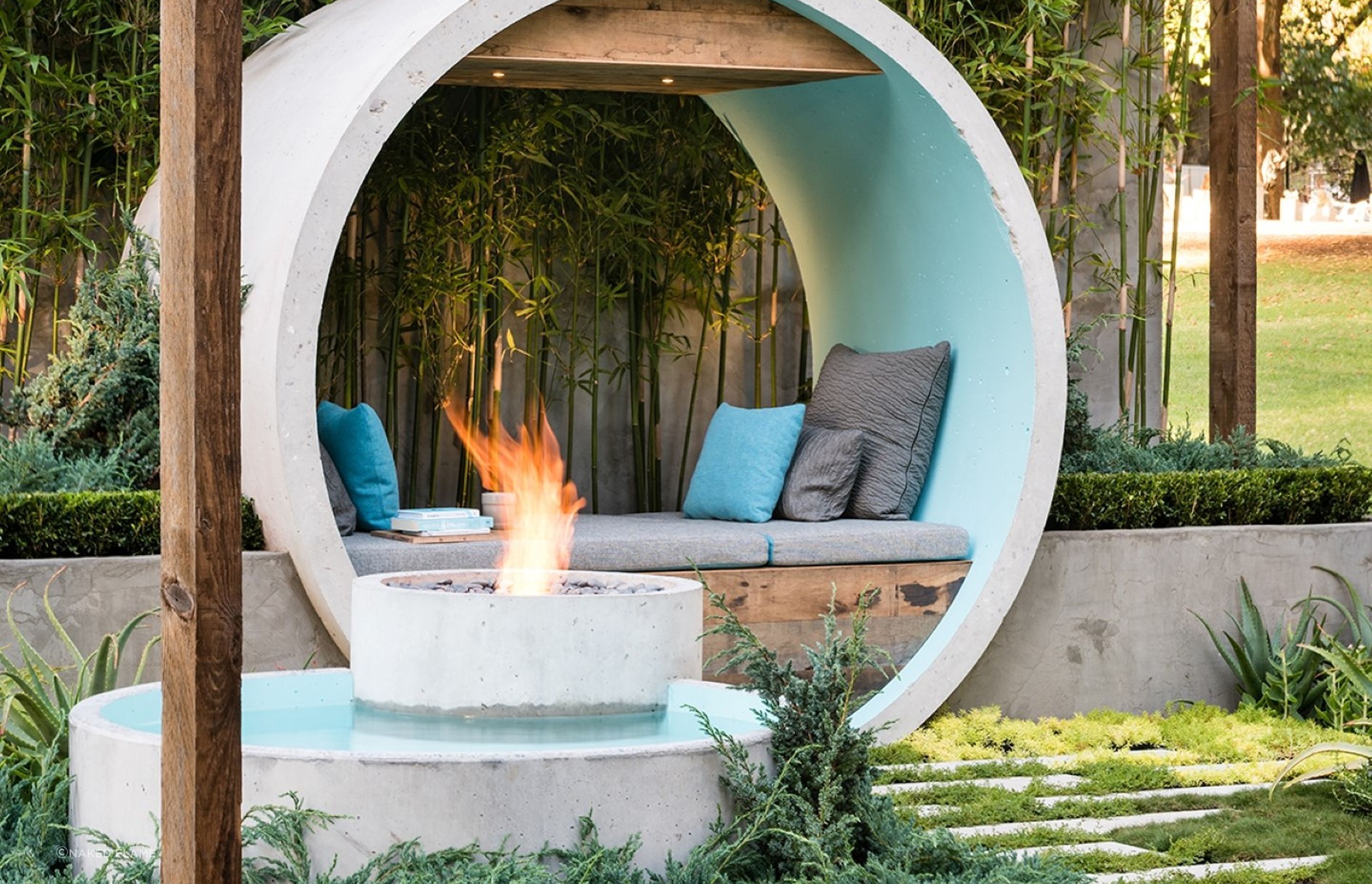 Incorporating your fire pit into a water feature, stylishly done here with the EcoSmart AB8 Ethanol Fireplace, can result in a stunning focal point for your backyard.